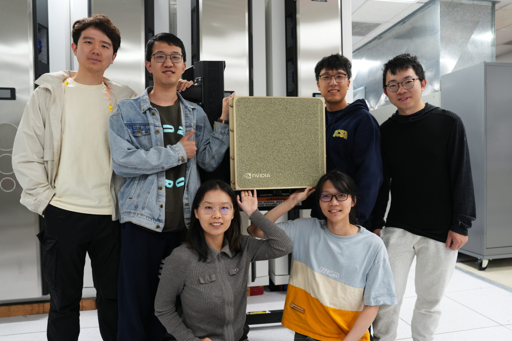 Researchers standing around the DGX B200 system inside the San Diego Supercomputing Center.