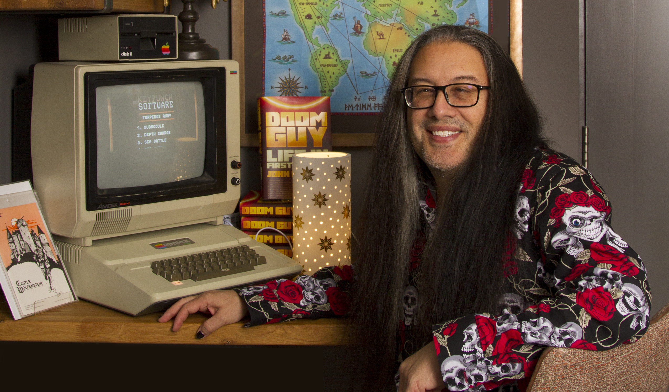 John Romero sitting in front of his Apple 2