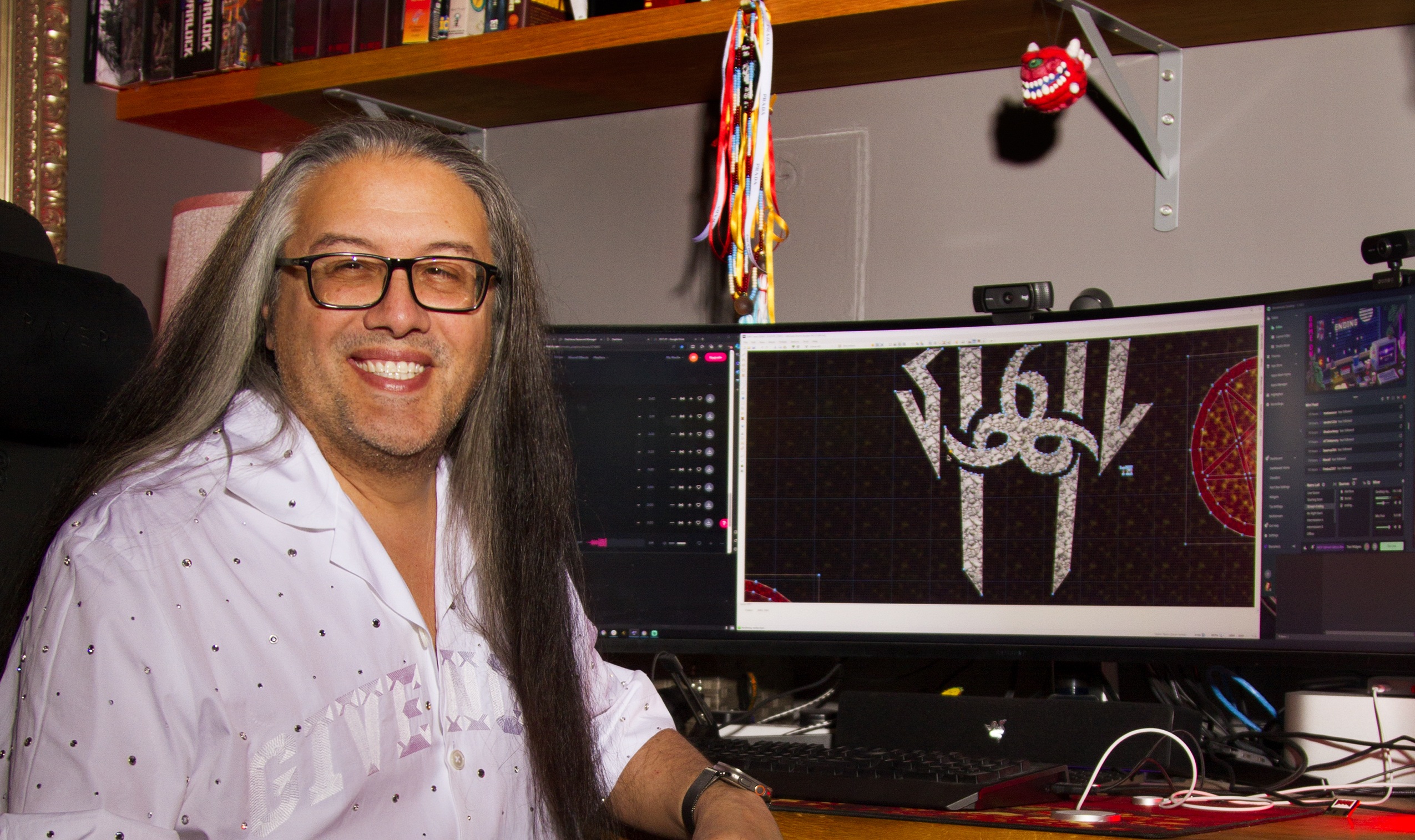 John Romero sitting in front of his very wide monitor