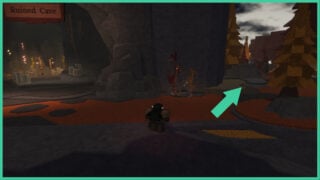 An entrance to the Ruined Cave to the left and an arrow pointing to the pathway on the right in The Forge.