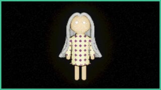 One of the dolls from Play Things, which has white hair and a cream coloured dress with dark circles.