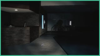The spider monster from Huntsman, hiding by the wall in the dark as the flashlight shines on it, casting a shadow.