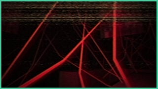Multiple red beams of light stretching across the screen in different directions as a fuzzy TV screen filter overlays the camera in ANATOMY.