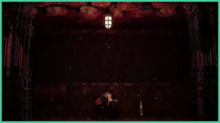 A man sits on the ground in the elevator with his head in his hands as teeth appear on the ceiling in Kletka.