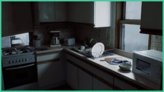 A kitchen in Silent Hill: Townfall. It looks lived in, with dishes in the drying rack, used appliances, and other kitchen utensils. A kitchen in Silent Hill: Townfall. It looks lived in, with dishes in the drying rack, used appliances, and other kitchen utensils.