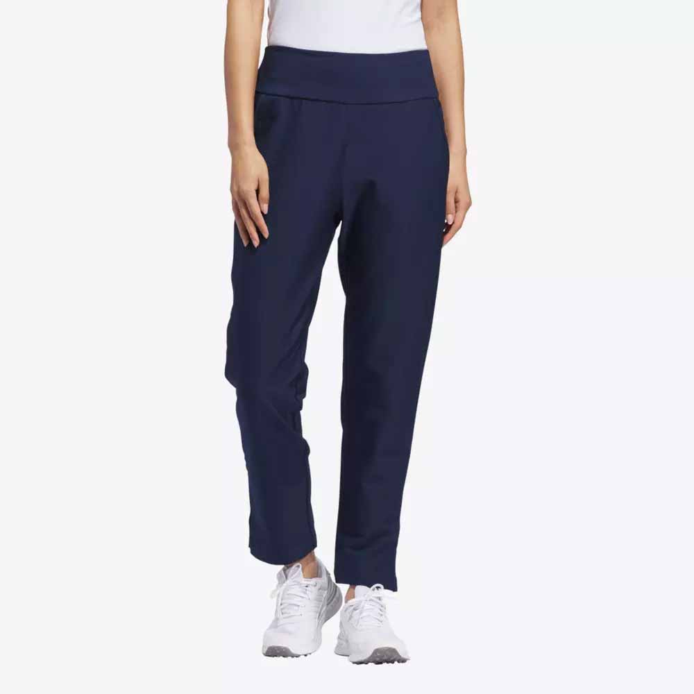 A person models navy blue jogger pants, a white top, and white sneakers&mdash;stylish apparel perfect for Mother&rsquo;s Day. The image is cropped at the shoulders with a plain light background.