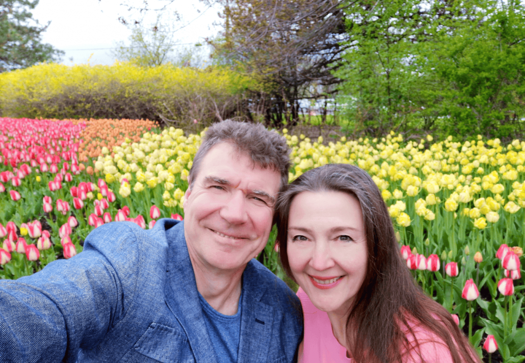 Older couple is surrounded by blooming tulips, romance, love, marriage, couples