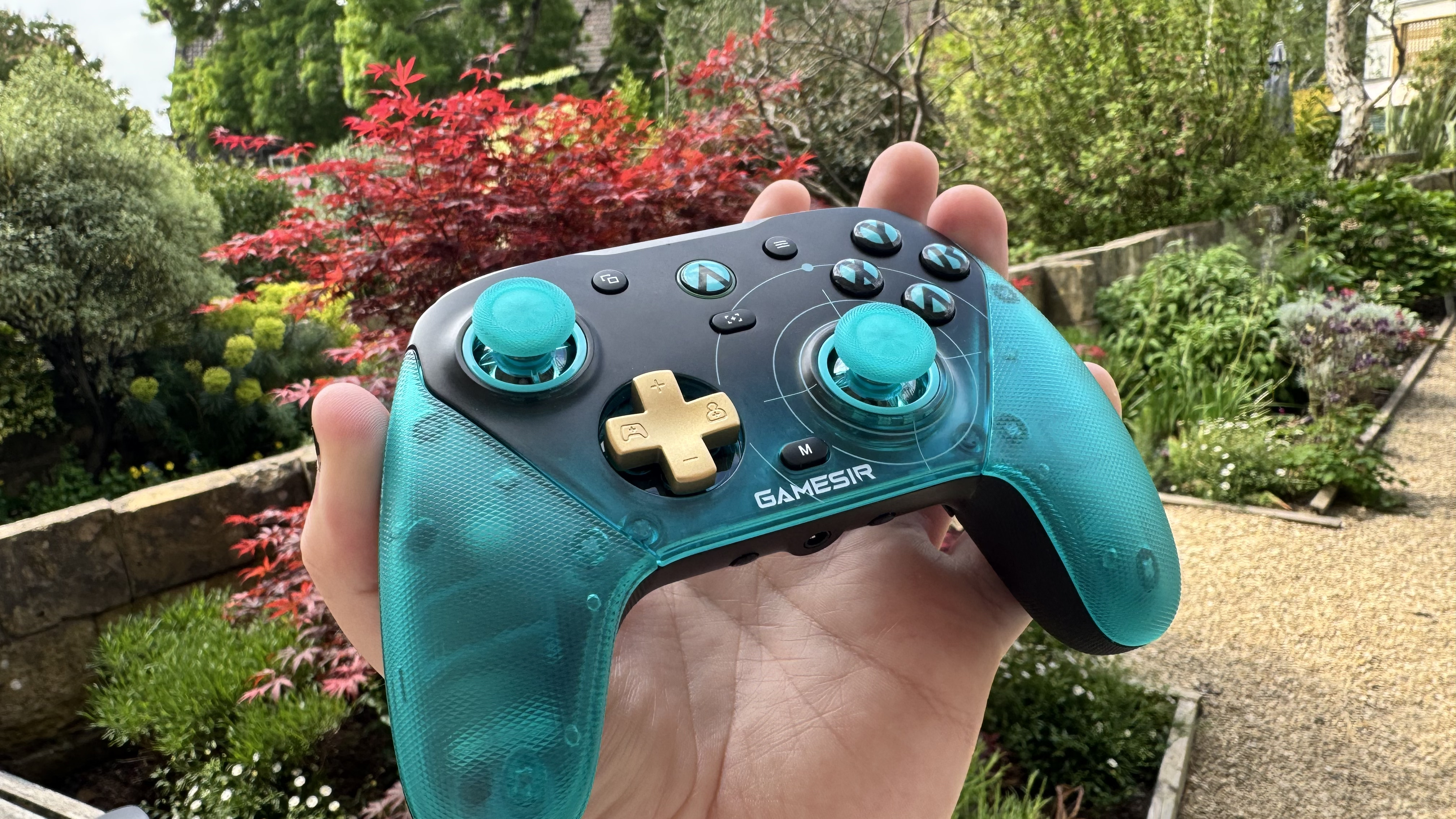 The GameSir G7 Pro 8K Aimlabs Edition in a hand from the front left