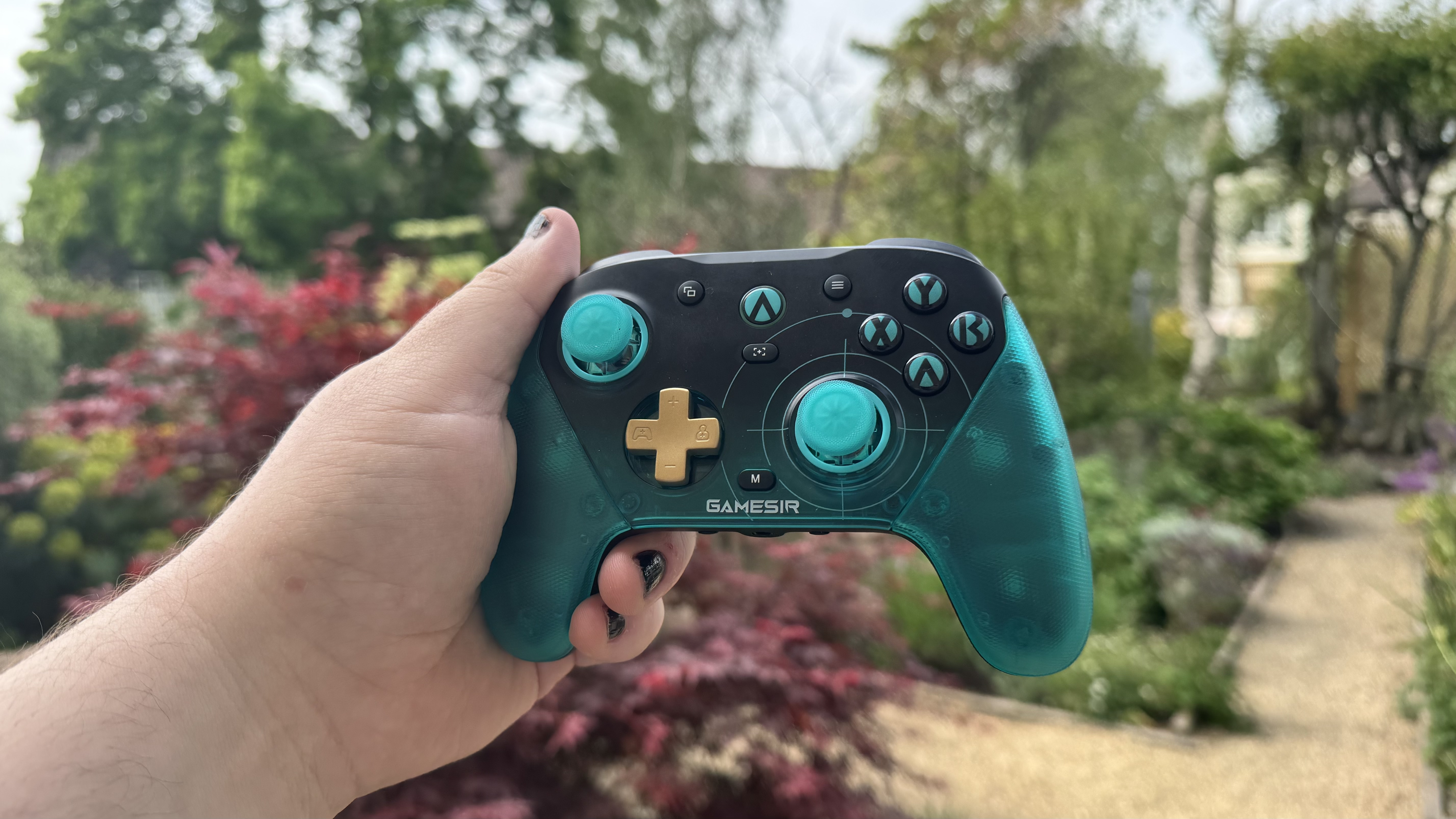 The GameSir G7 Pro 8K Aimlabs Edition from the front, in a hand