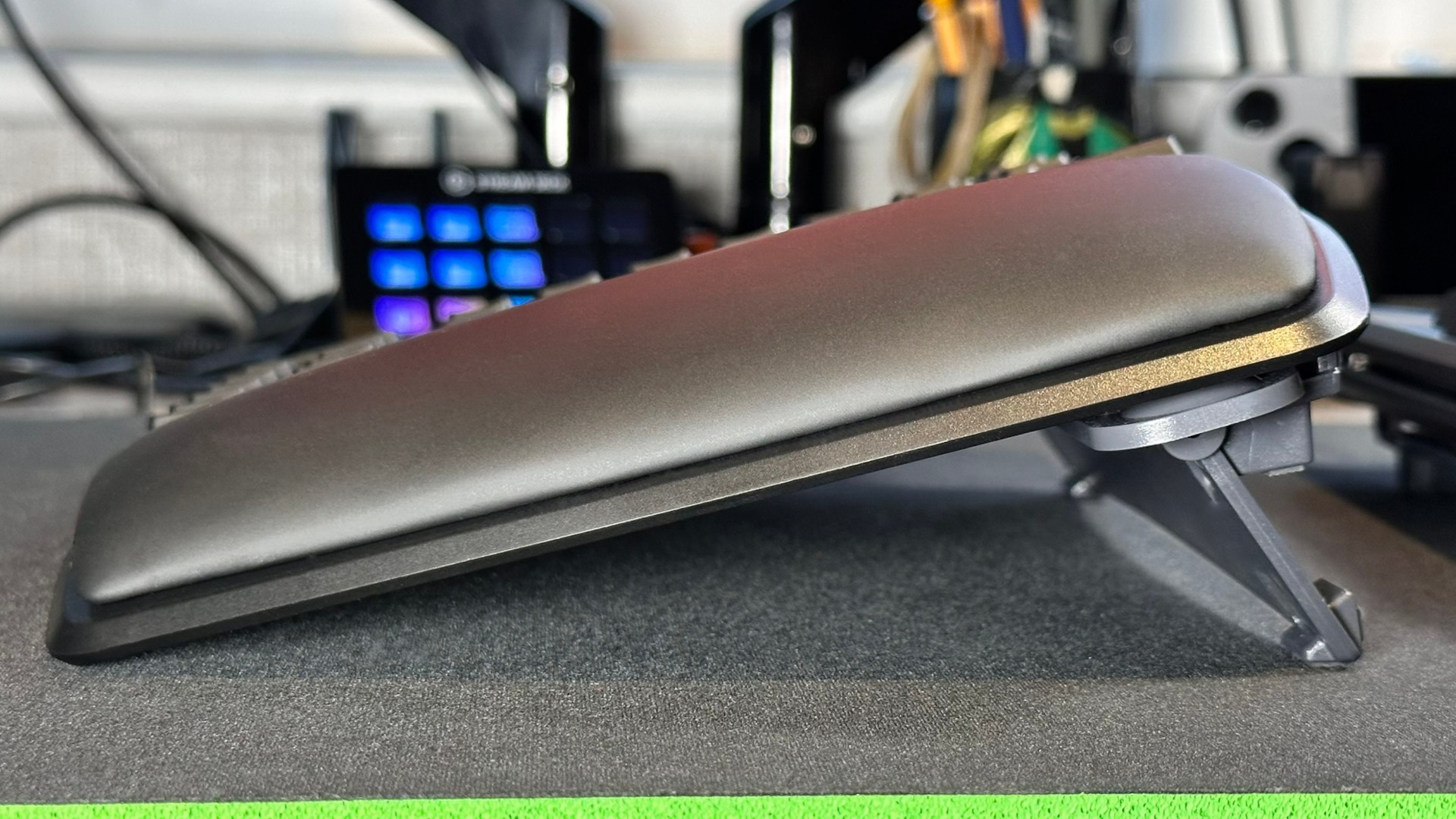 A side view photograph of the Kinesis Gaming Freestyle Edge RGB Plus ergonomic keyboard, showing the lift kit set to 15 degrees