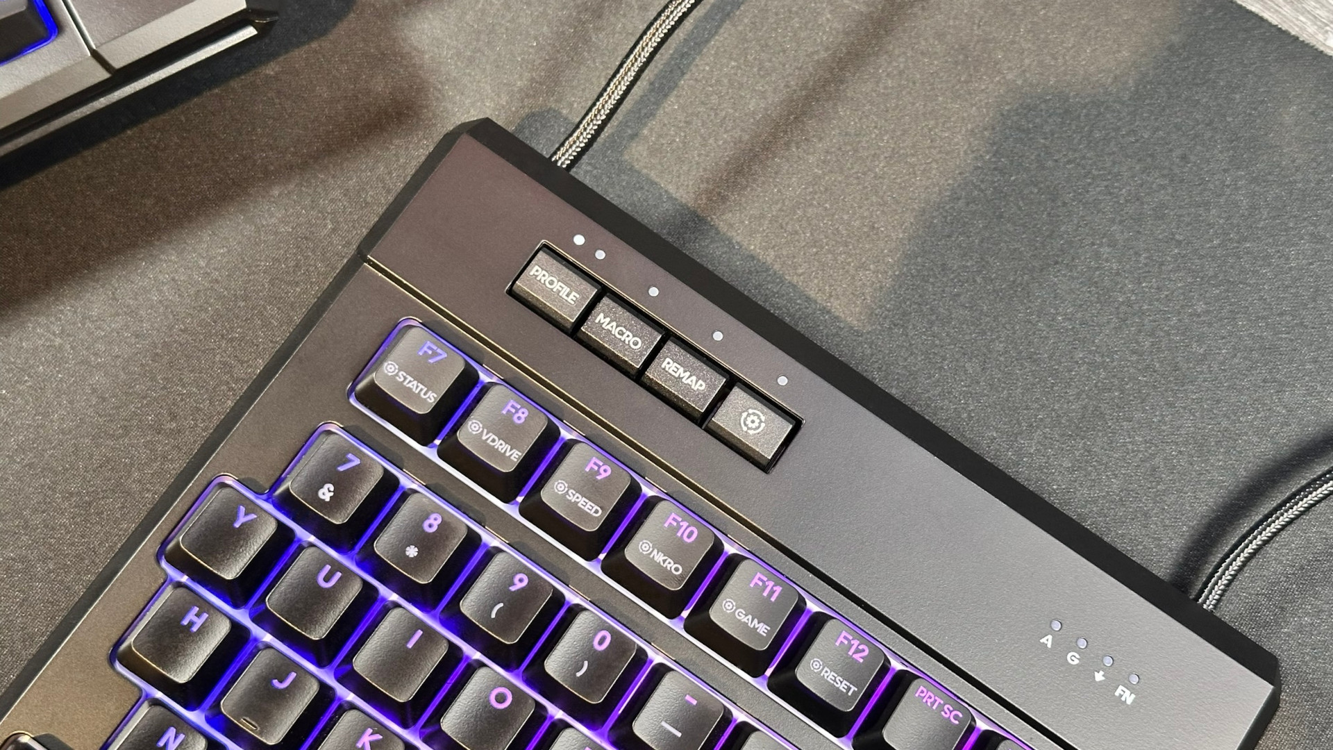 A photograph of the Kinesis Gaming Freestyle Edge RGB Plus ergonomic keyboard, focusing on the additional keys to change profile and mode