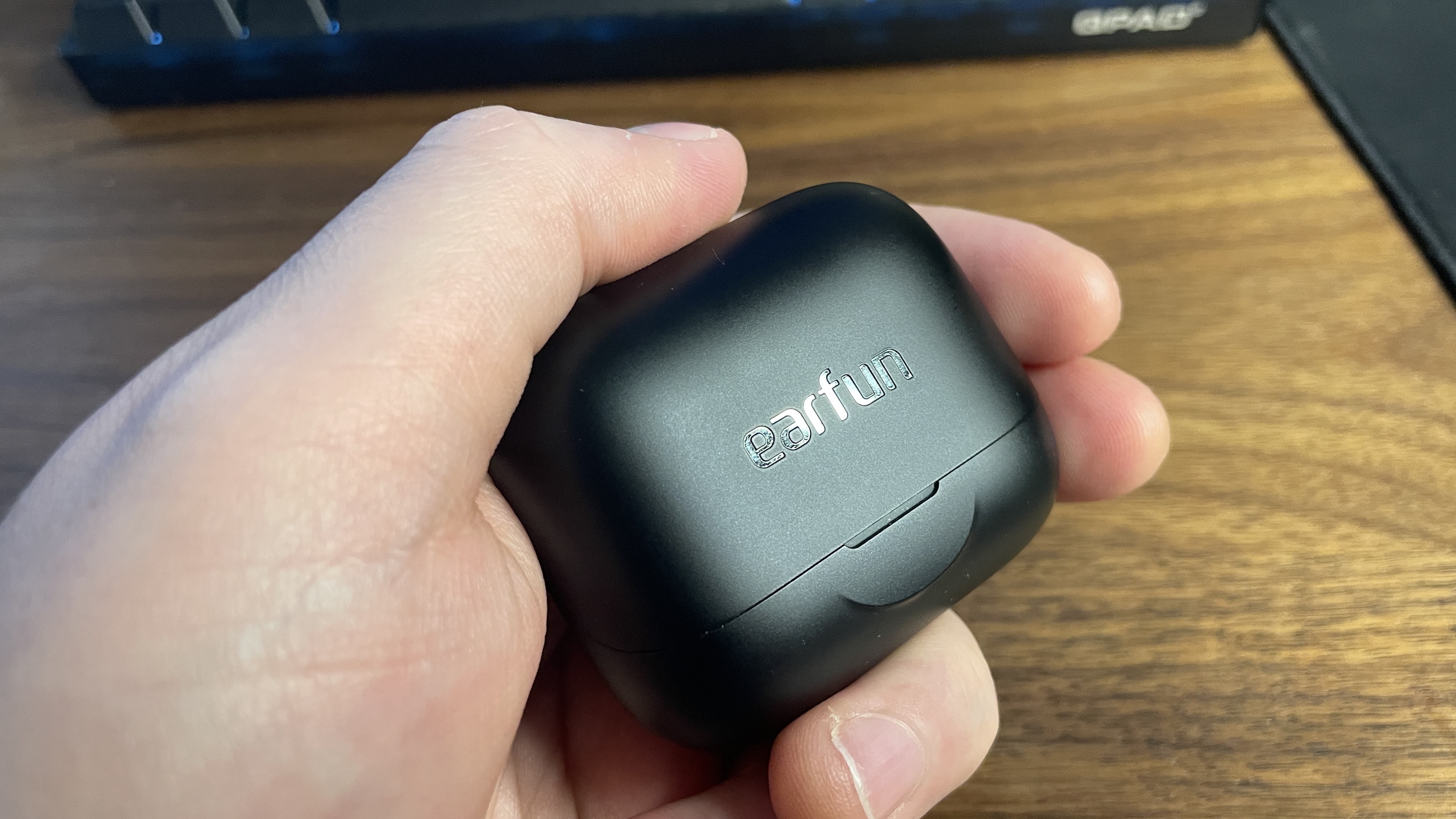 EarFun Air Pro 4+ earbuds inside their case.