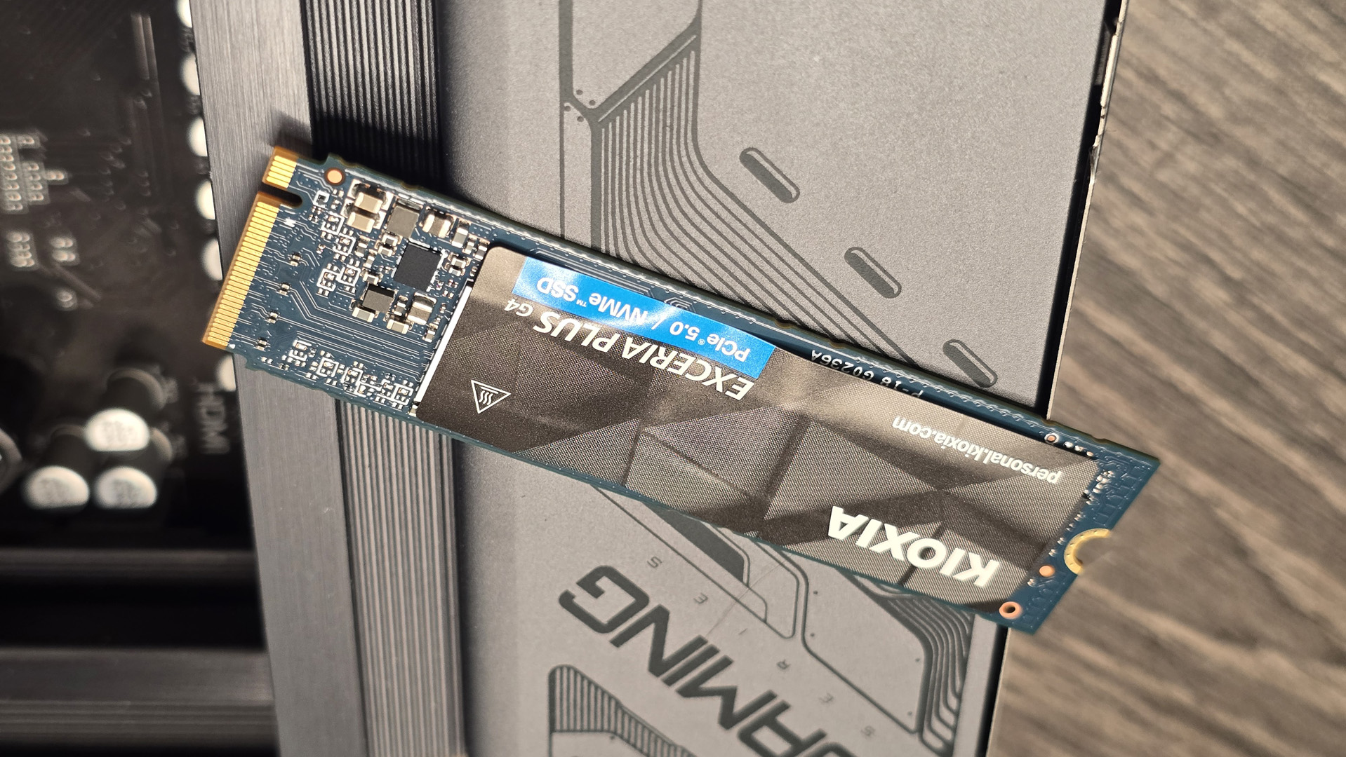 The Kioxia Exceria Plus G4 on a desk, ready to be installed inside a gaming PC.