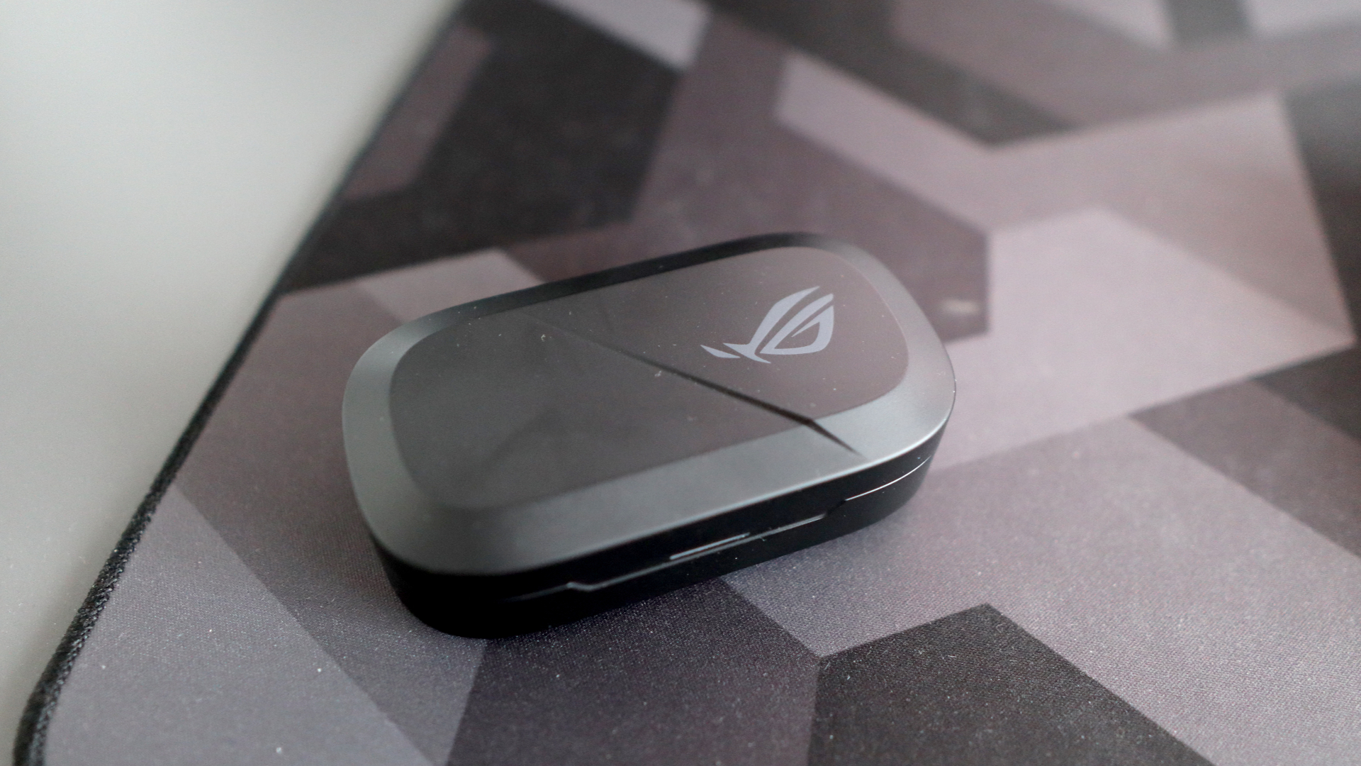 Asus ROG Cetra Open earbuds on a deskmat.