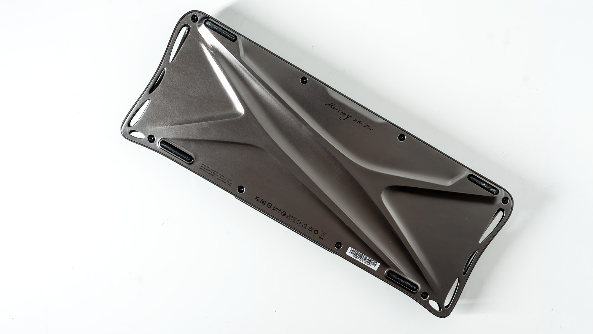 A Gravastar Mercury V60 Pro gaming keyboard with a shiny aluminium shell on a white desk.