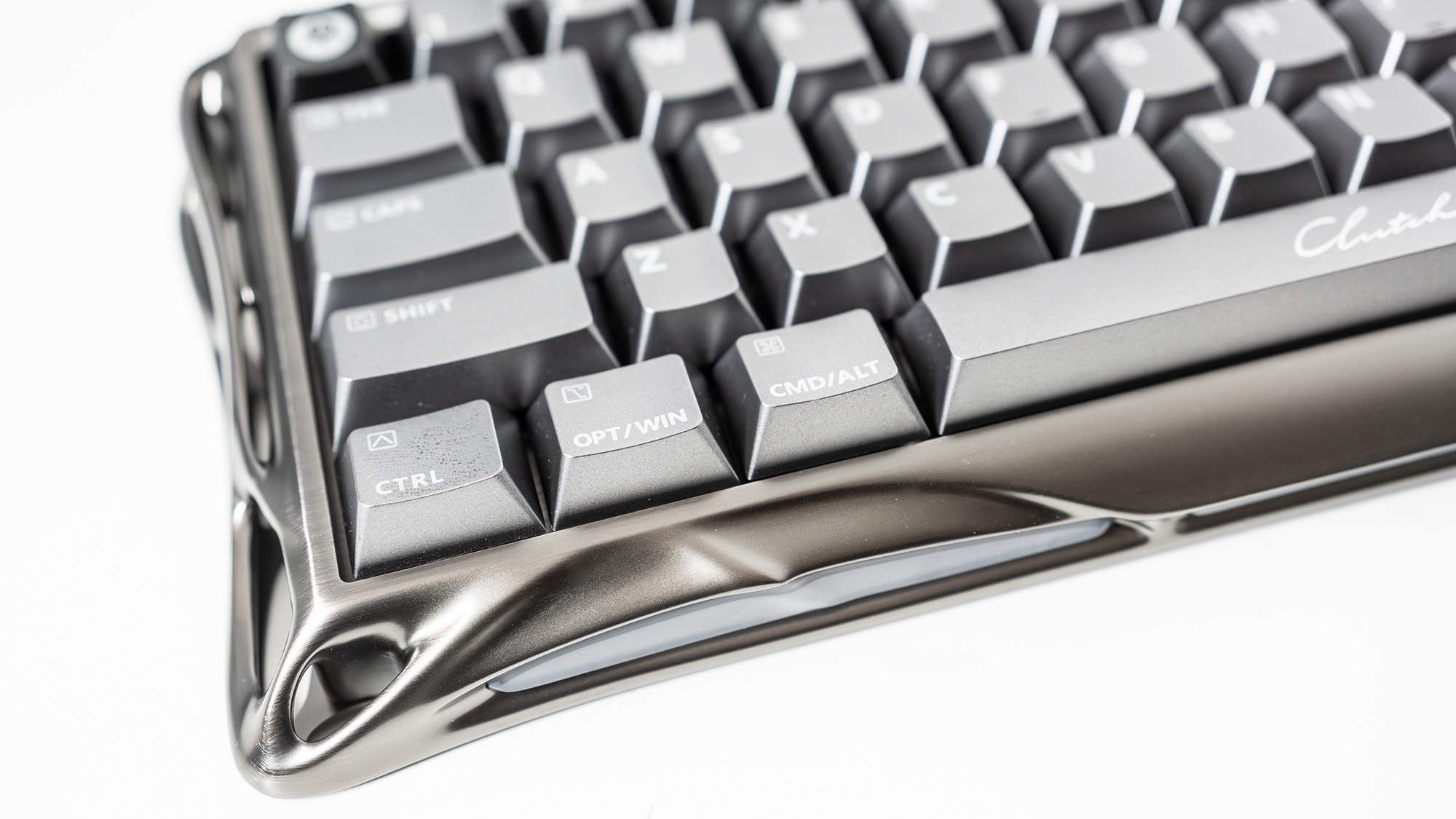 A Gravastar Mercury V60 Pro gaming keyboard with a shiny aluminium shell on a white desk.
