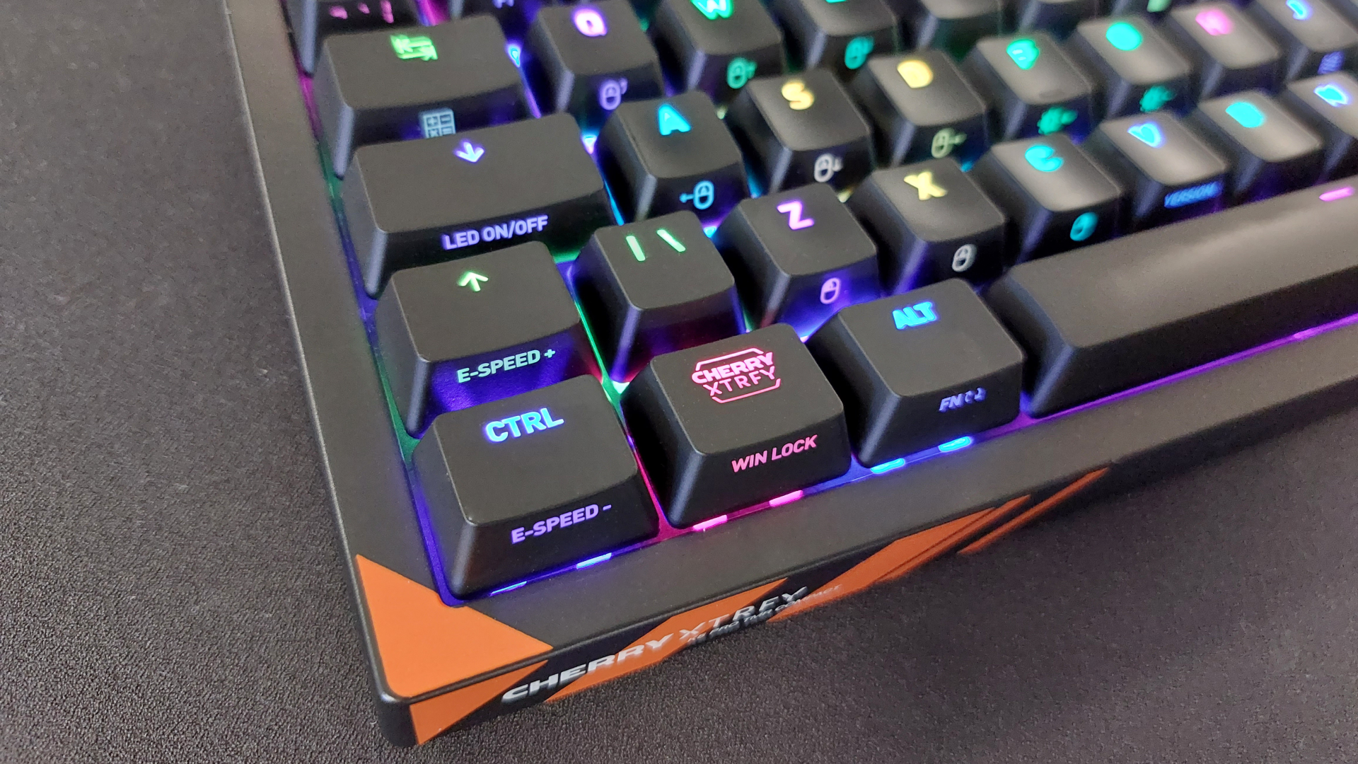 The Cherry K5 Pro TMR Compact on a black mousepad with the RGB lights on.