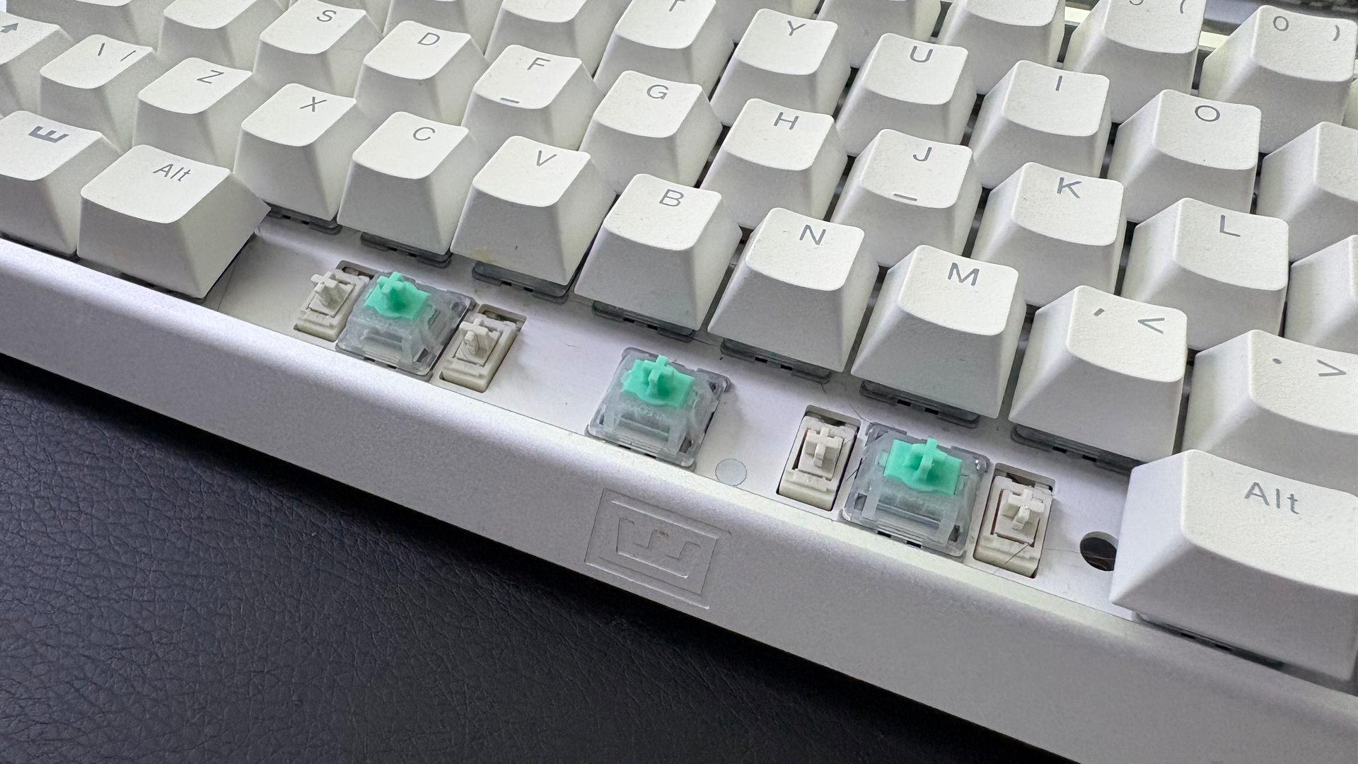 The Wooting 60HE v2 with a split spacebar on a desk alongside the Wooting 80HE with a normal spacebar.