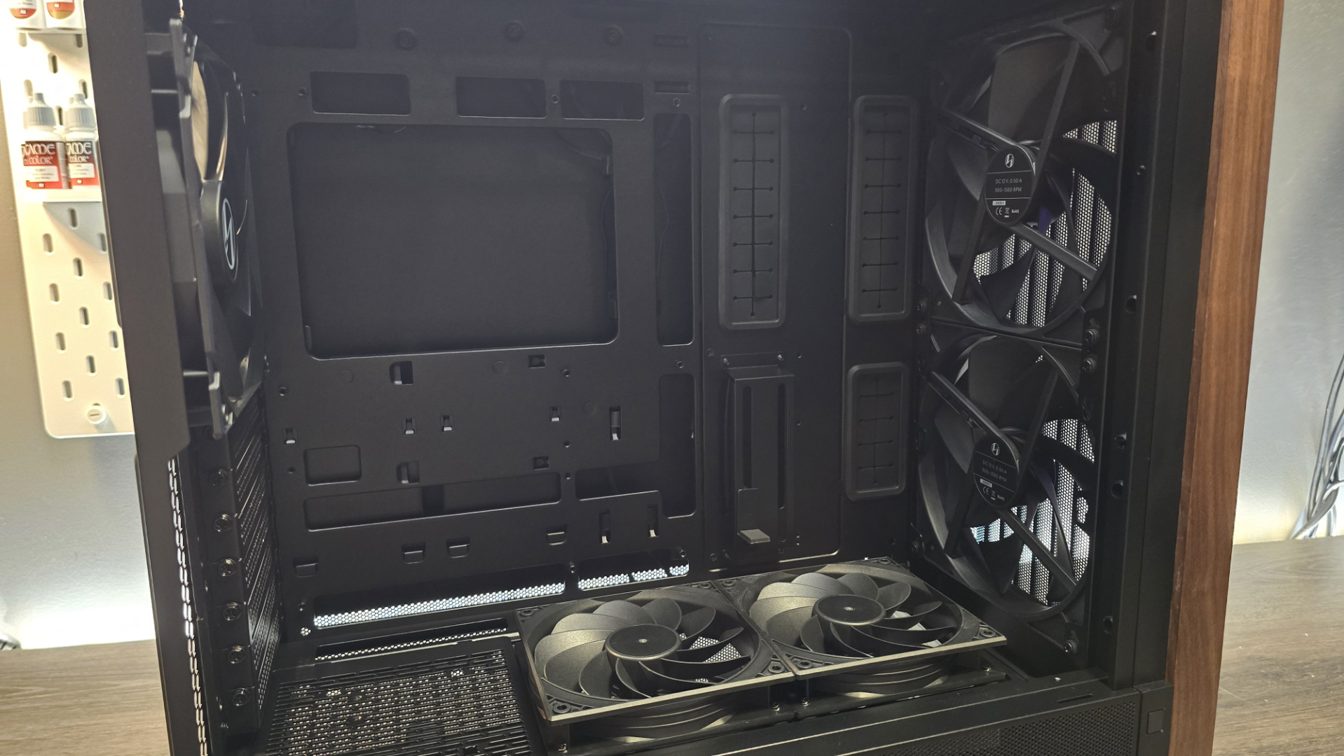 A Lian Li Lancool 217 on a desk with various components installed inside it.