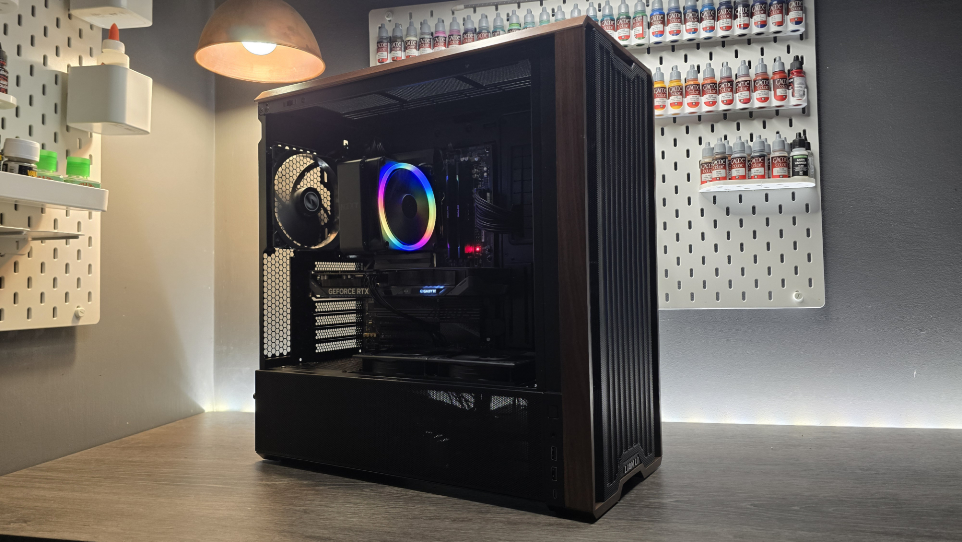 A Lian Li Lancool 217 on a desk with various components installed inside it.