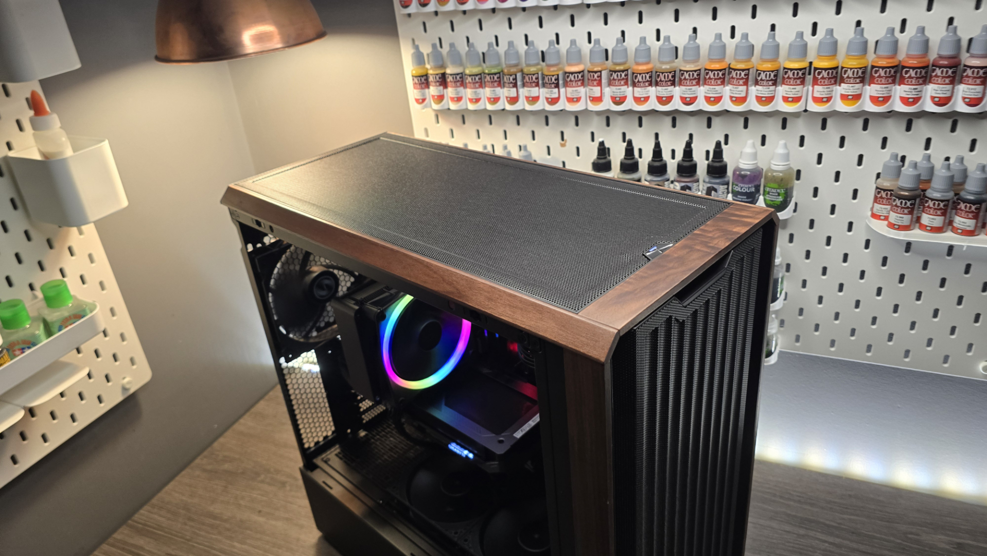 A Lian Li Lancool 217 on a desk with various components installed inside it.