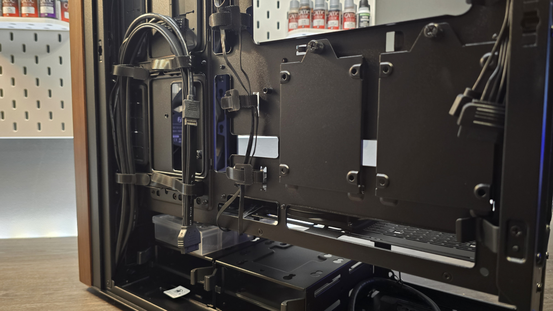 A Lian Li Lancool 217 on a desk with various components installed inside it.