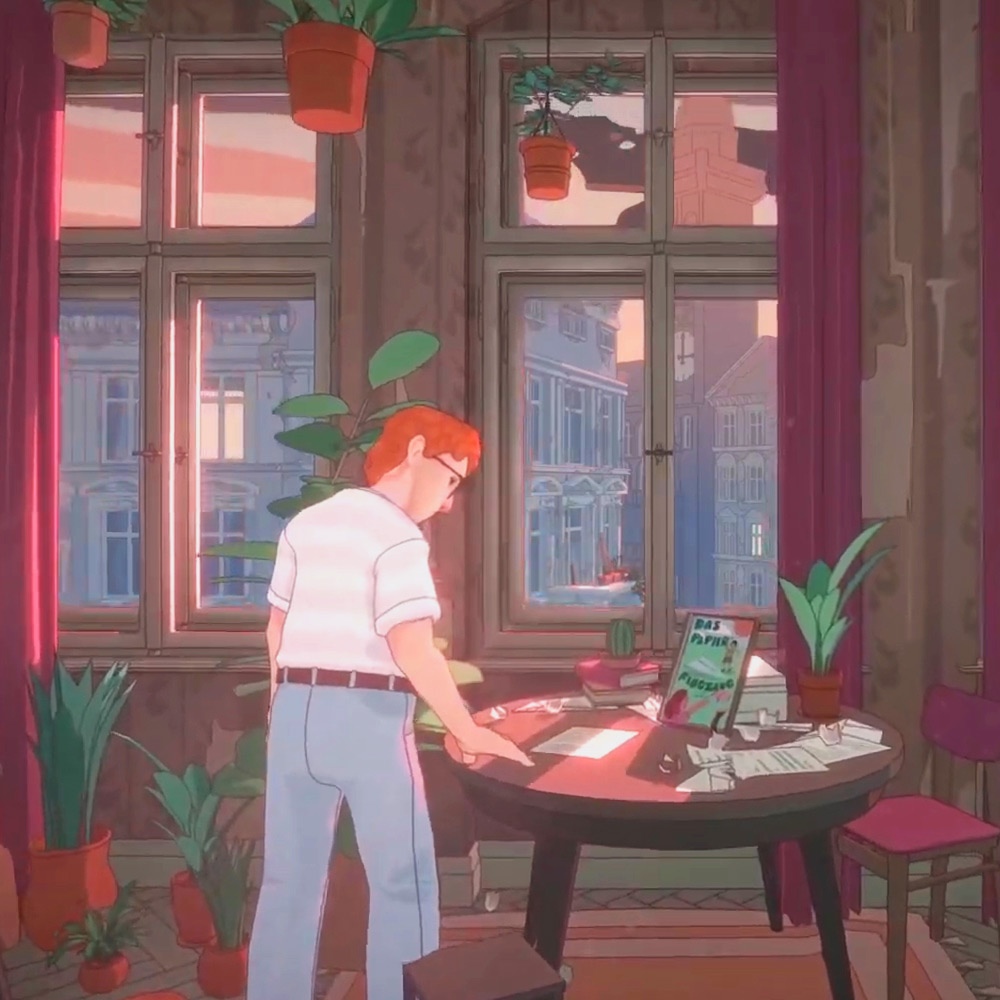 A man with red hair looking down at a table with papers and plants