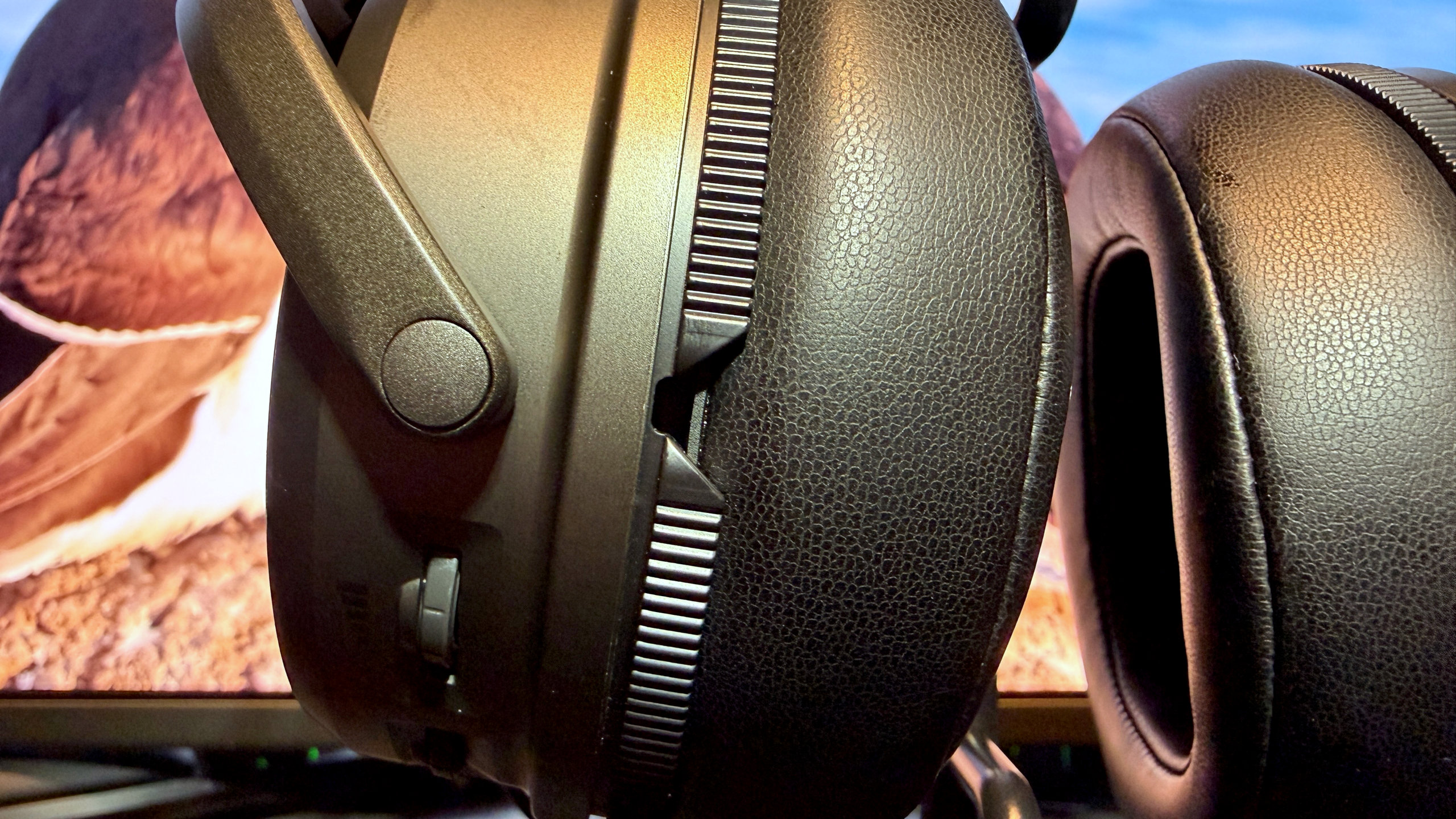 A photo of the Audeze Maxwell 2 wireless gaming headset, focusing on one of the pressure ports in Audeze's SLAM system