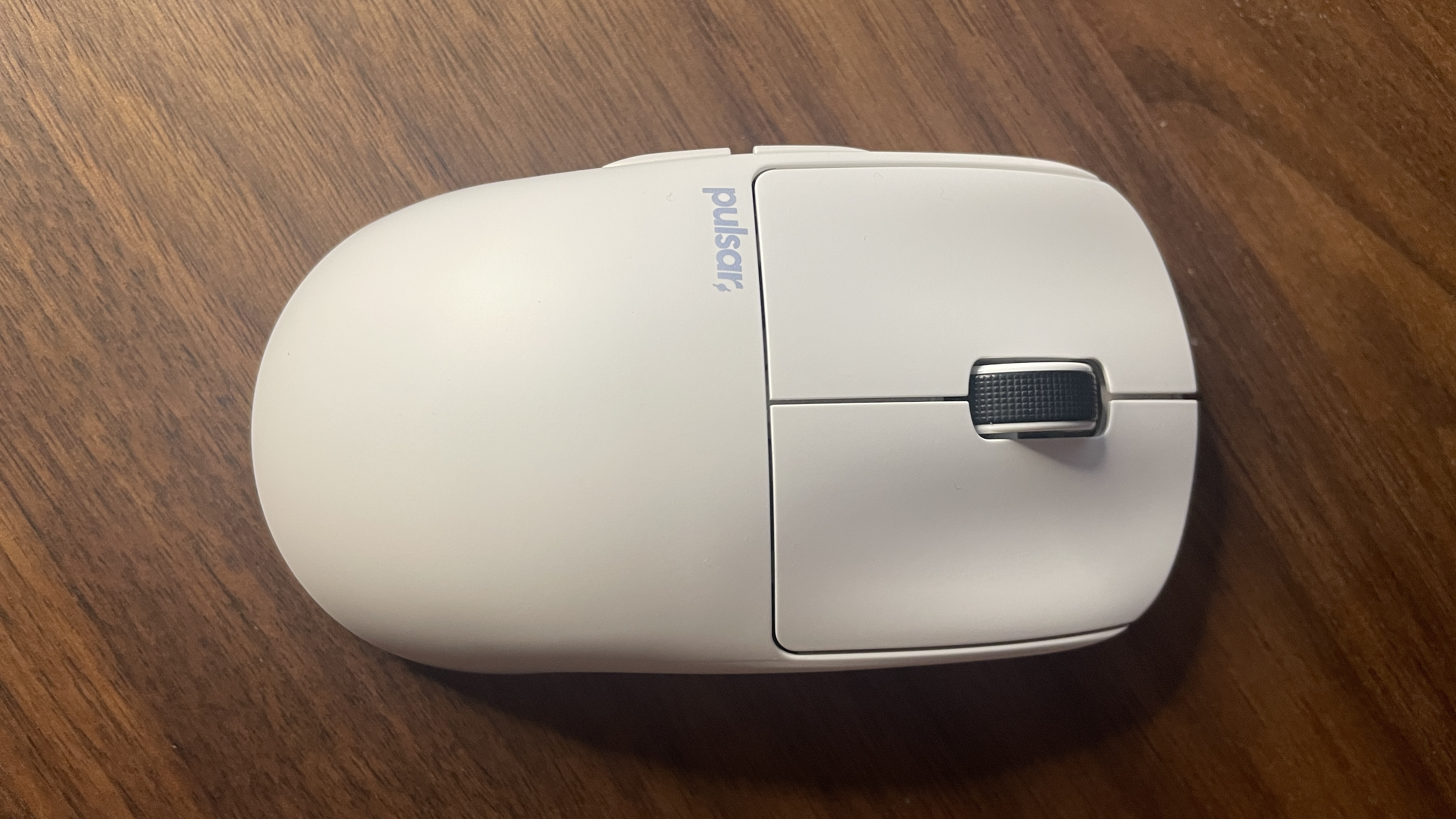 A Pulsar X2 CrazyLight Medium gaming mouse on a desk.