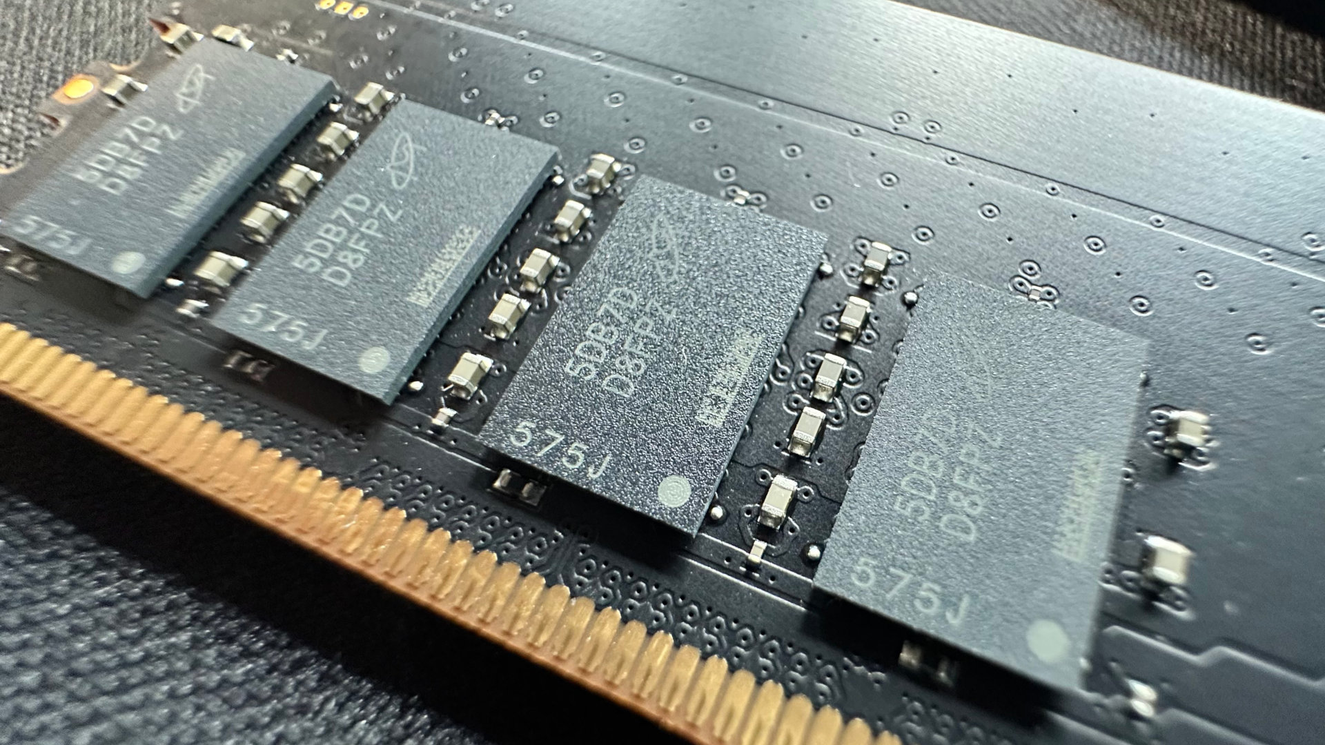 A close-up photo of a DRAM module in Crucial's 128 GB DDR5-6400 CUDIMM kit.