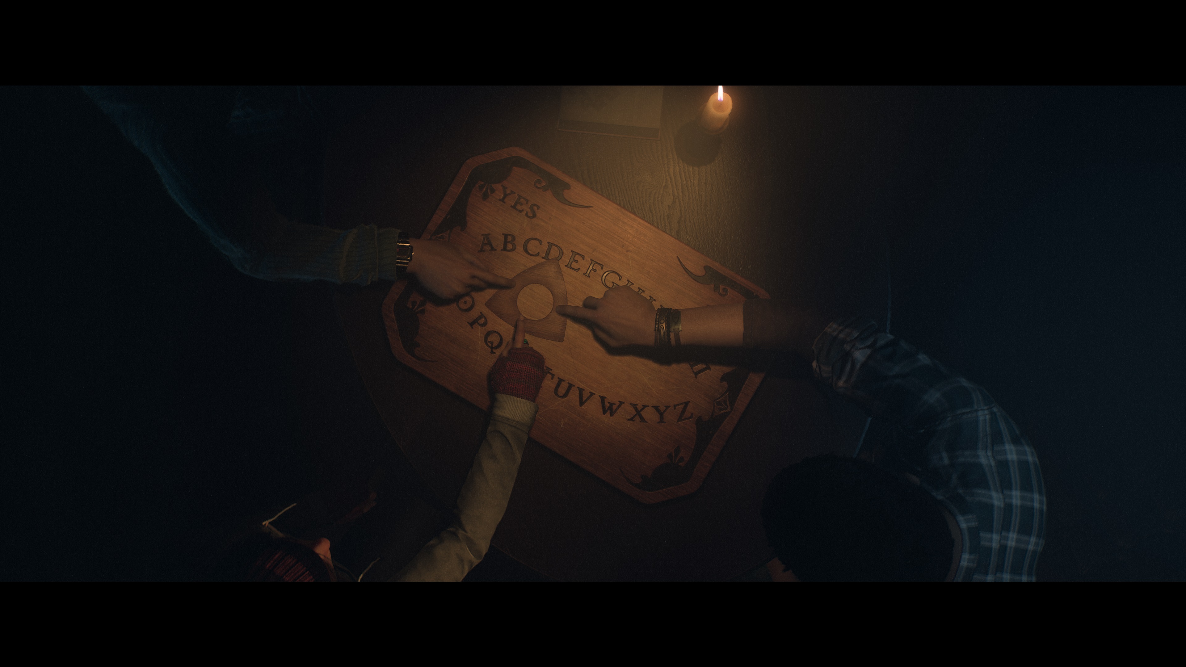 The gang playing with a Ouija board