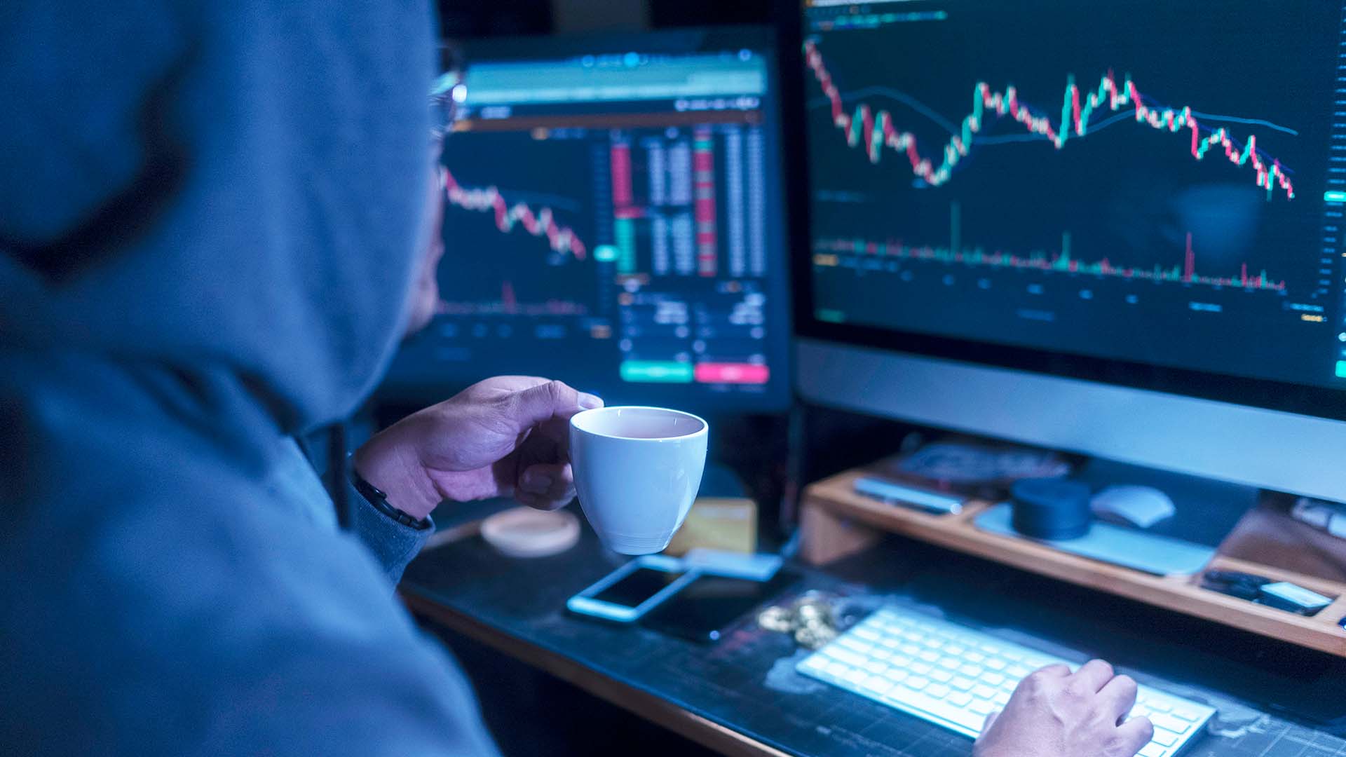 Back angle Hacker wearing hoodies cloth motivation emotion and typing coding to hacking cryptocurrency from internet at home