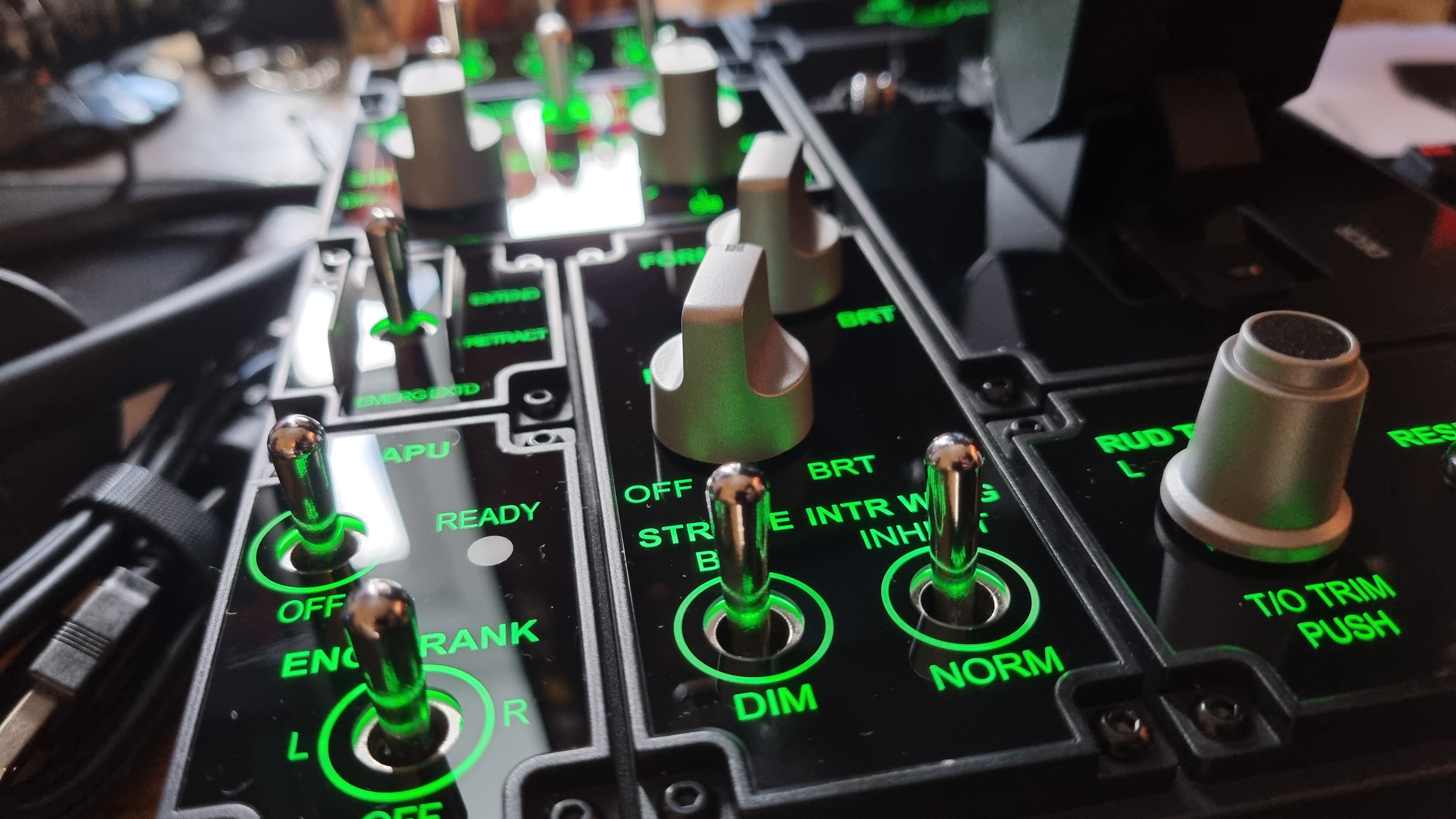 The various controls of the Moza MTP Throttle flight sim controller, lit up in green