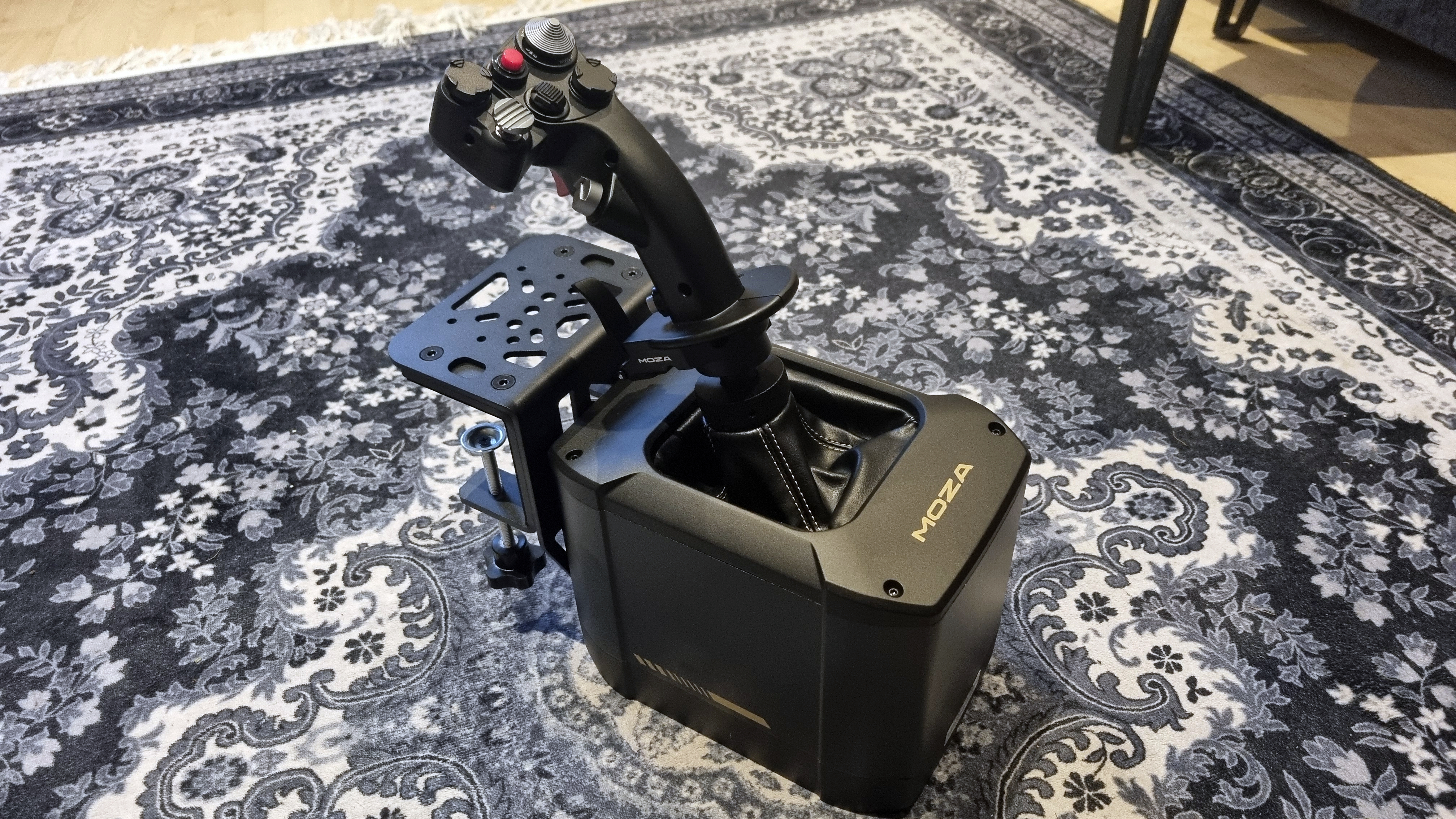 A Moza AB9 FFB Base and MH16 Flightstick on a rather attractive rug