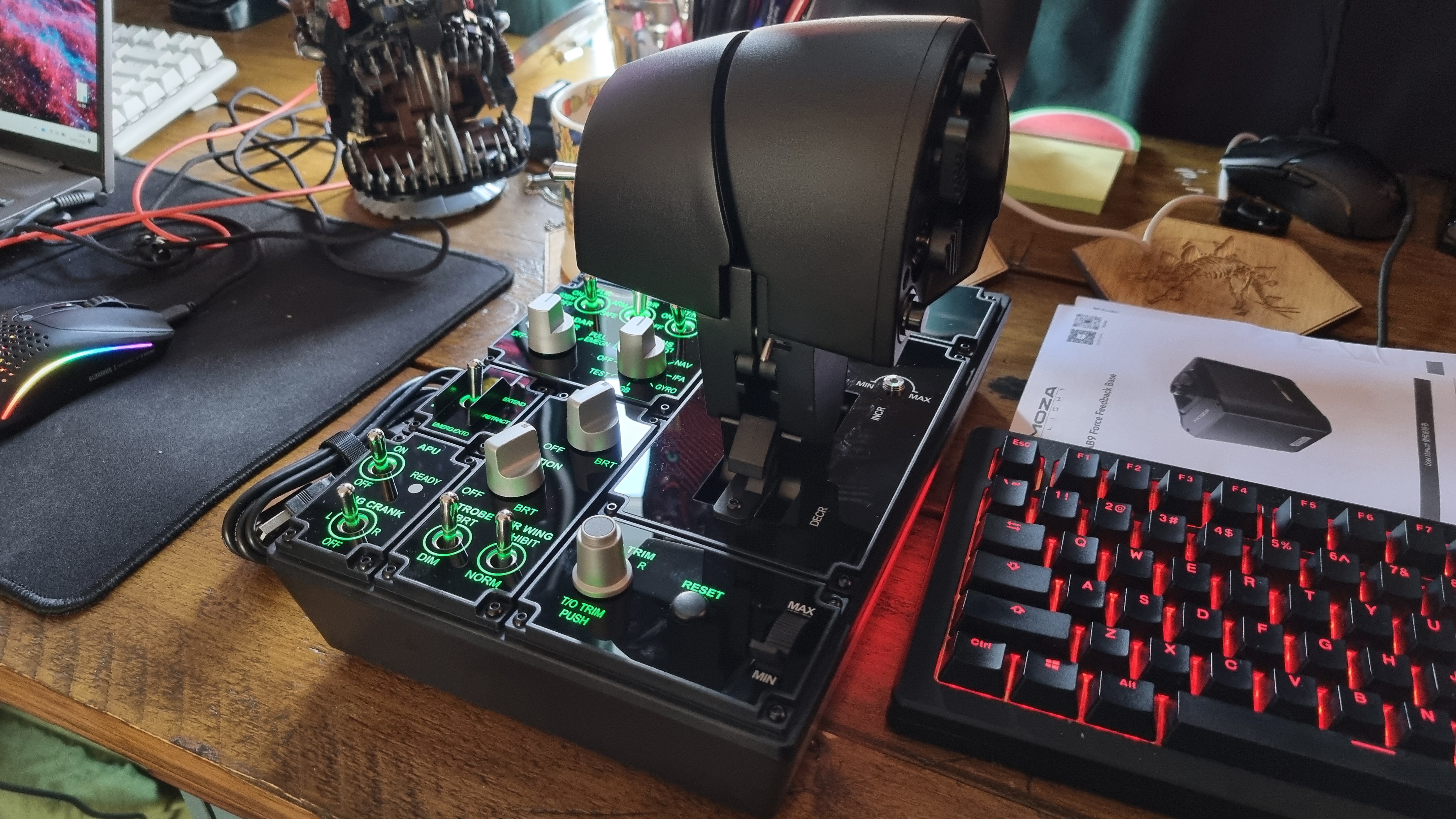 The various controls of the Moza MTP Throttle flight sim controller, lit up in green