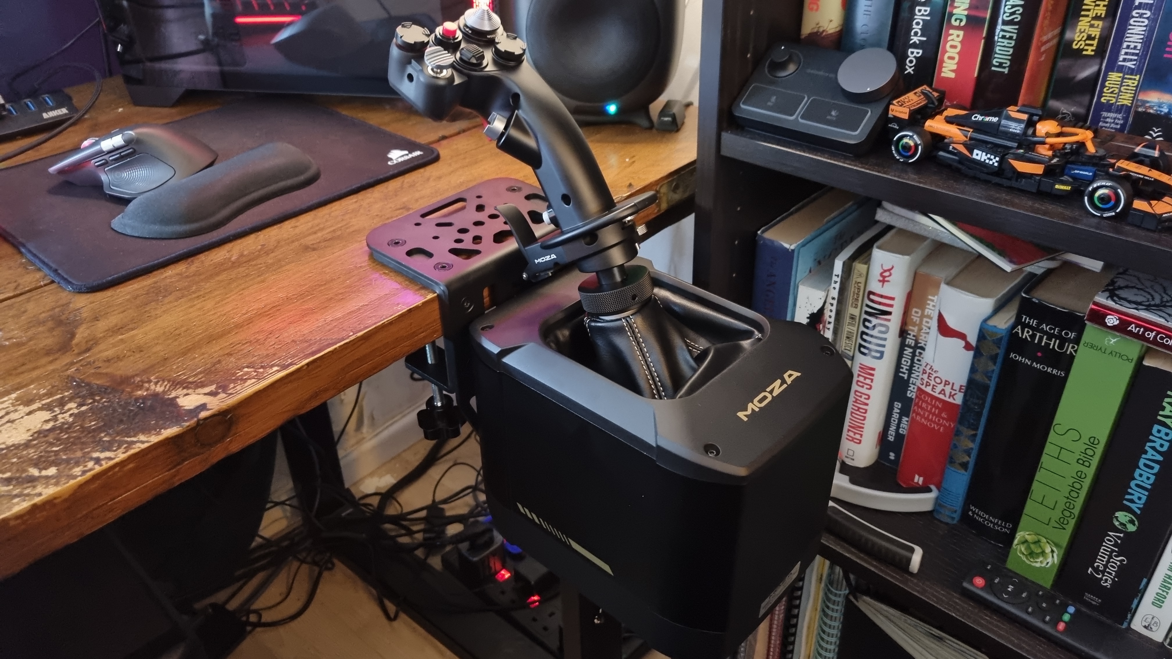 A Moza MH16 Flighstick attached to a Moza AB9 FFB Base, clamped to a desk