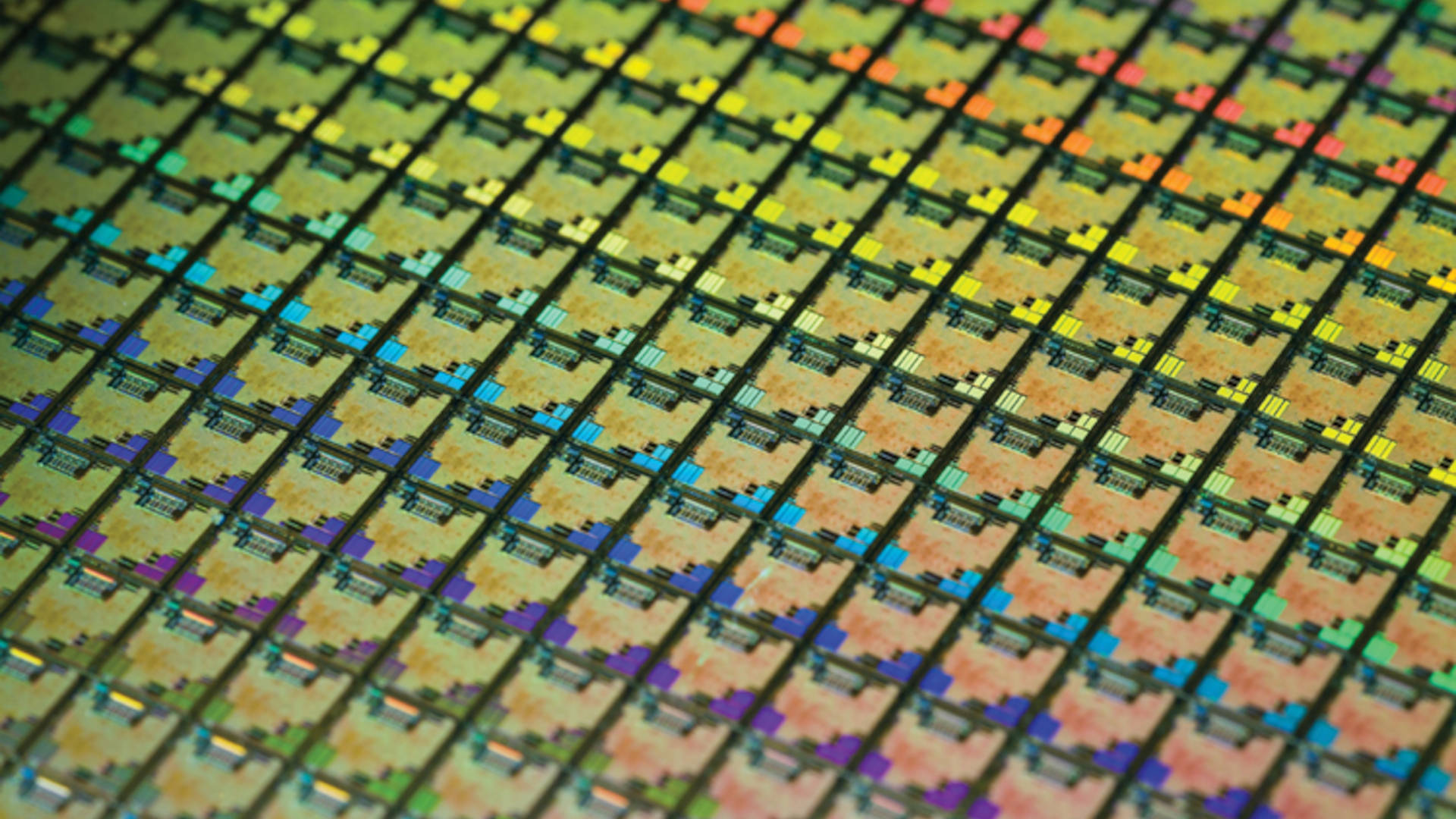 A photograph of a silicon wafer from TSMC, showing multiple rows of individual dies