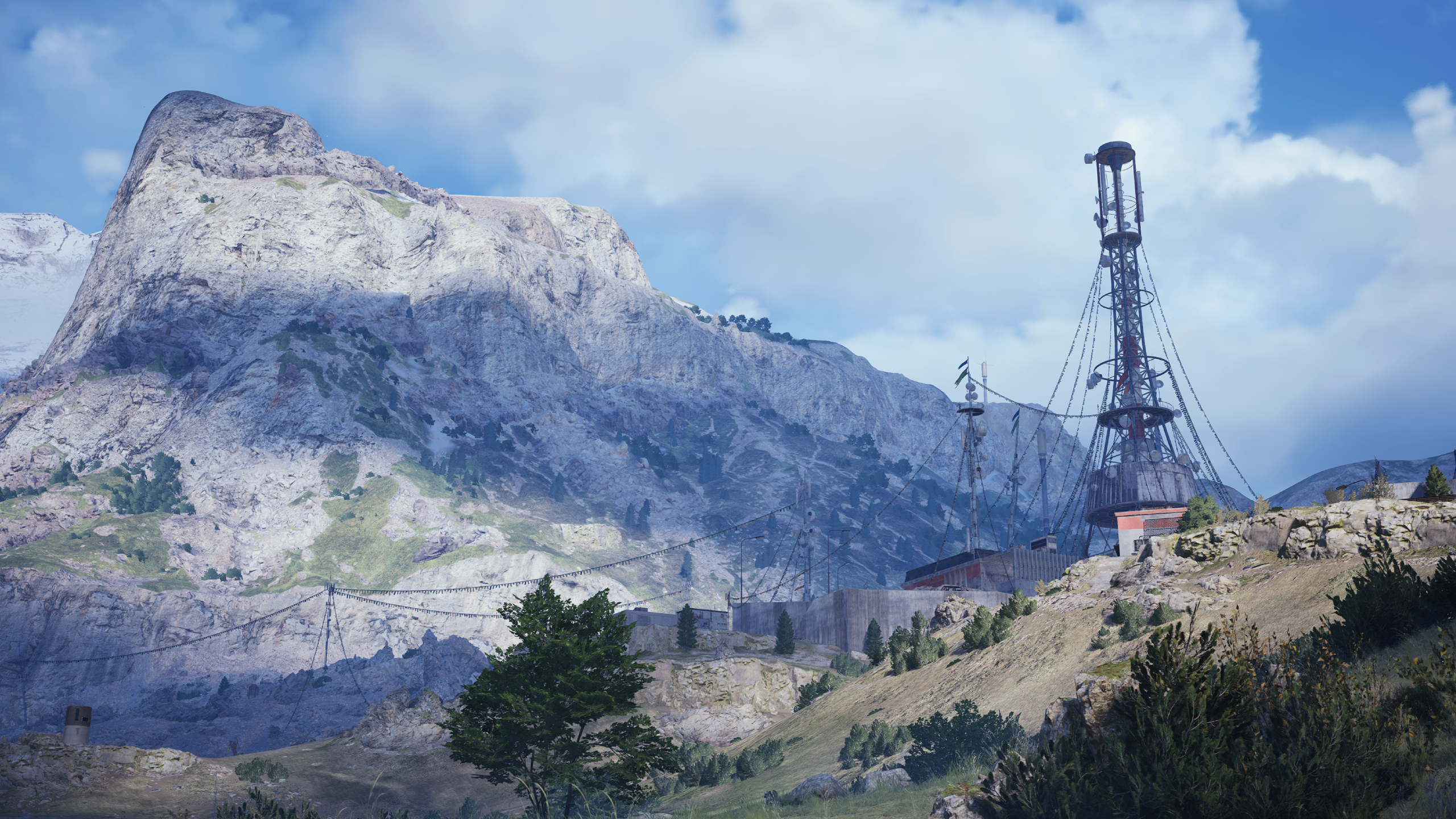 Arc Raiders quests: Scenic key art for the Blue Gate map, showing a large tower in the distance with a large mountain behind it.