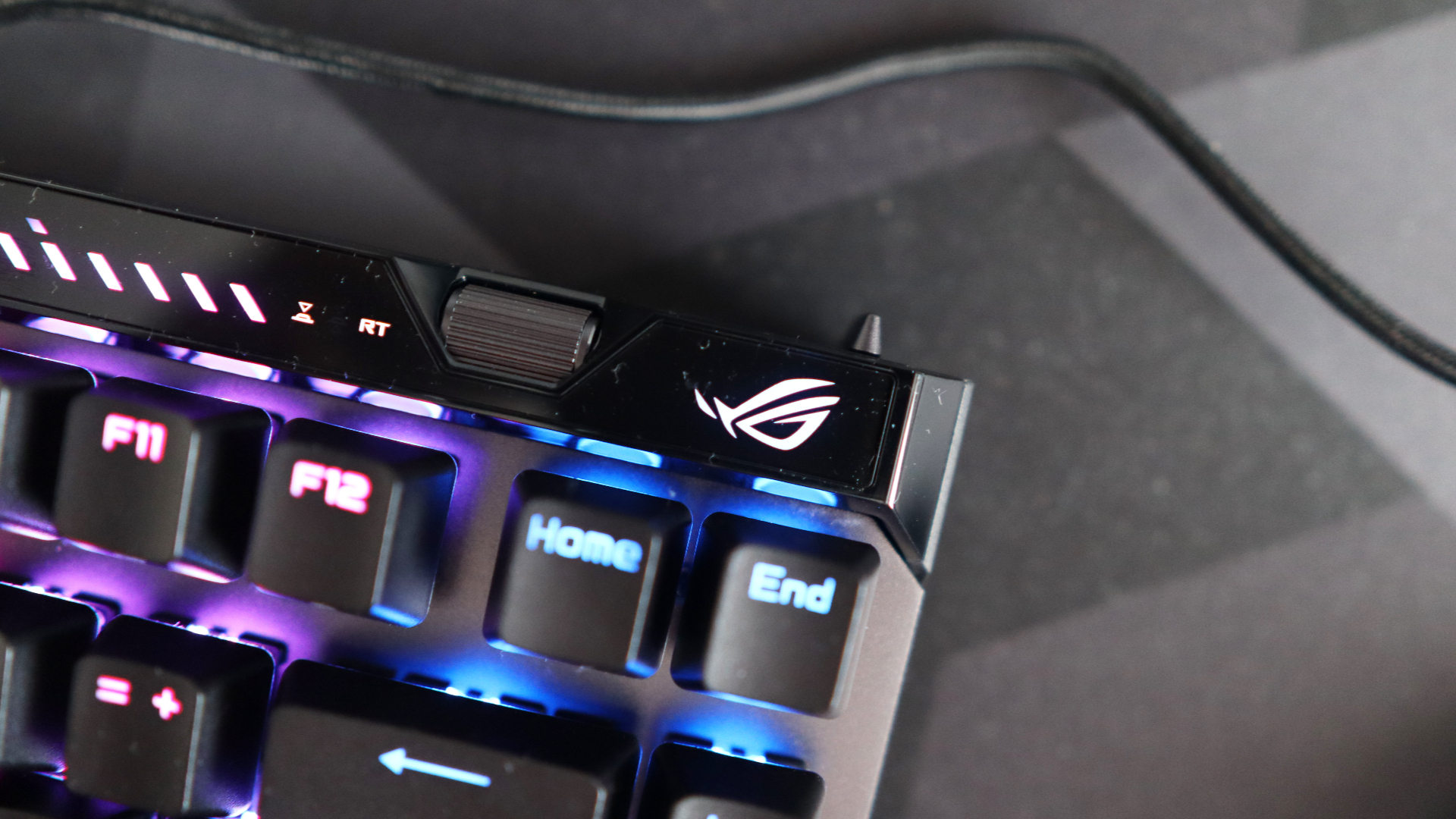 The Asus ROG Falchion Ace 75 HE on a desk with the lighting enabled.