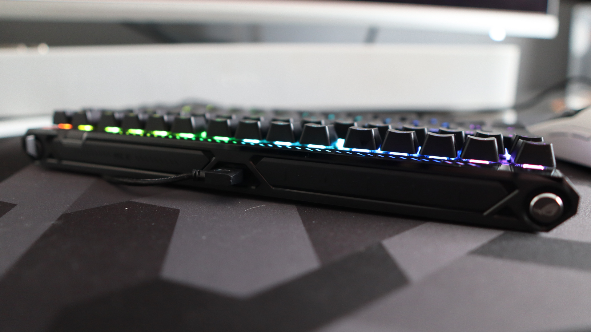 The Asus ROG Falchion Ace 75 HE on a desk with the lighting enabled.
