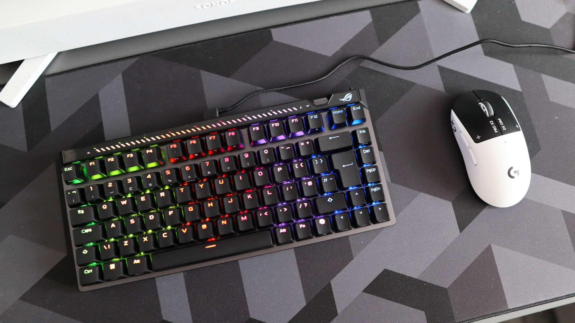 The Asus ROG Falchion Ace 75 HE on a desk with the lighting enabled.