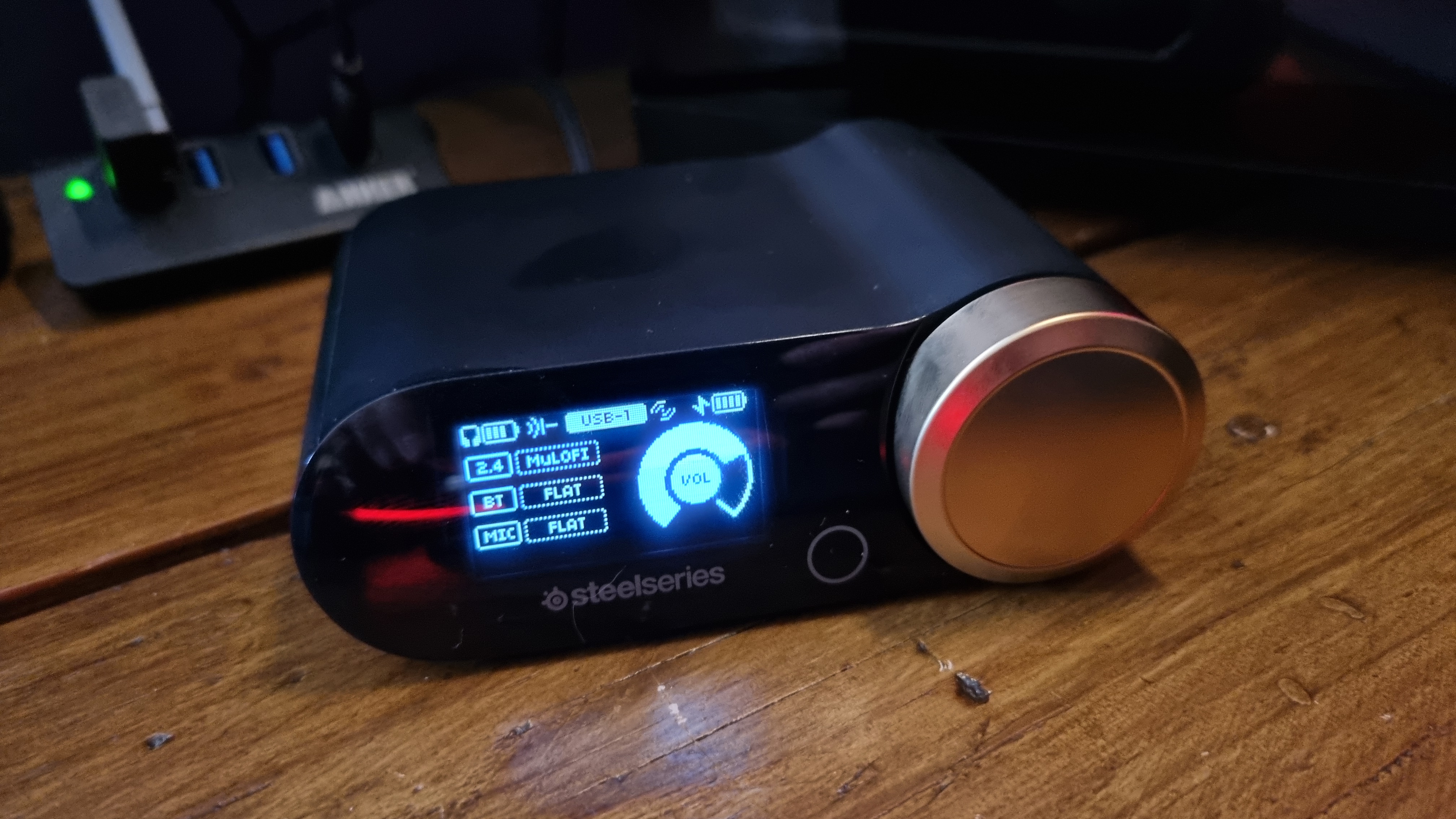 The Arctis Nova Elite Game Hub in Sage Gold, with swappable battery charging