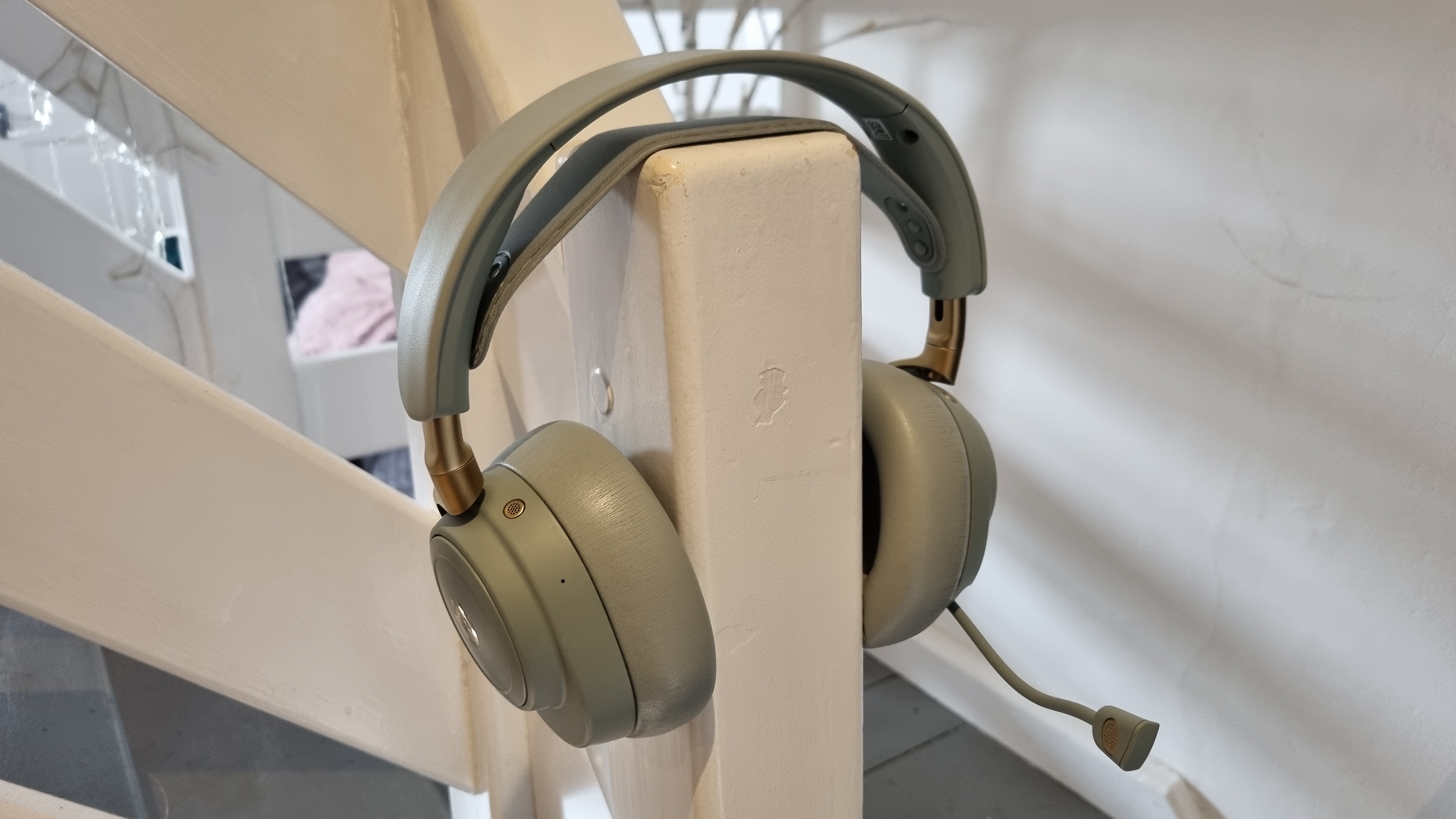 The SteelSeries Arctis Nova Elite gaming headset on a stair banister, to show what it looks like when worn on the head