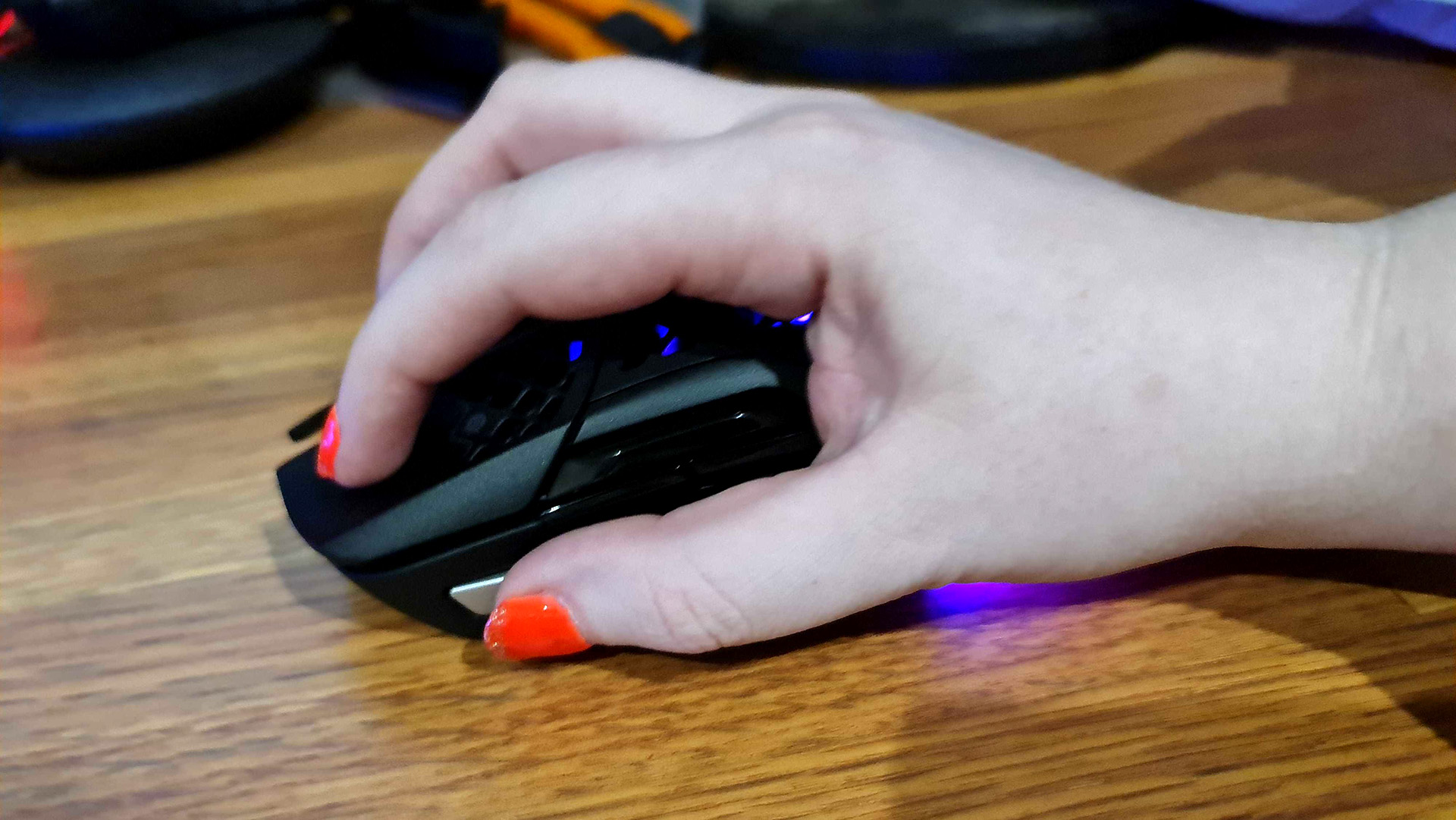 HyperX Aerox 5 gaming mouse with RGB lighting enabled.