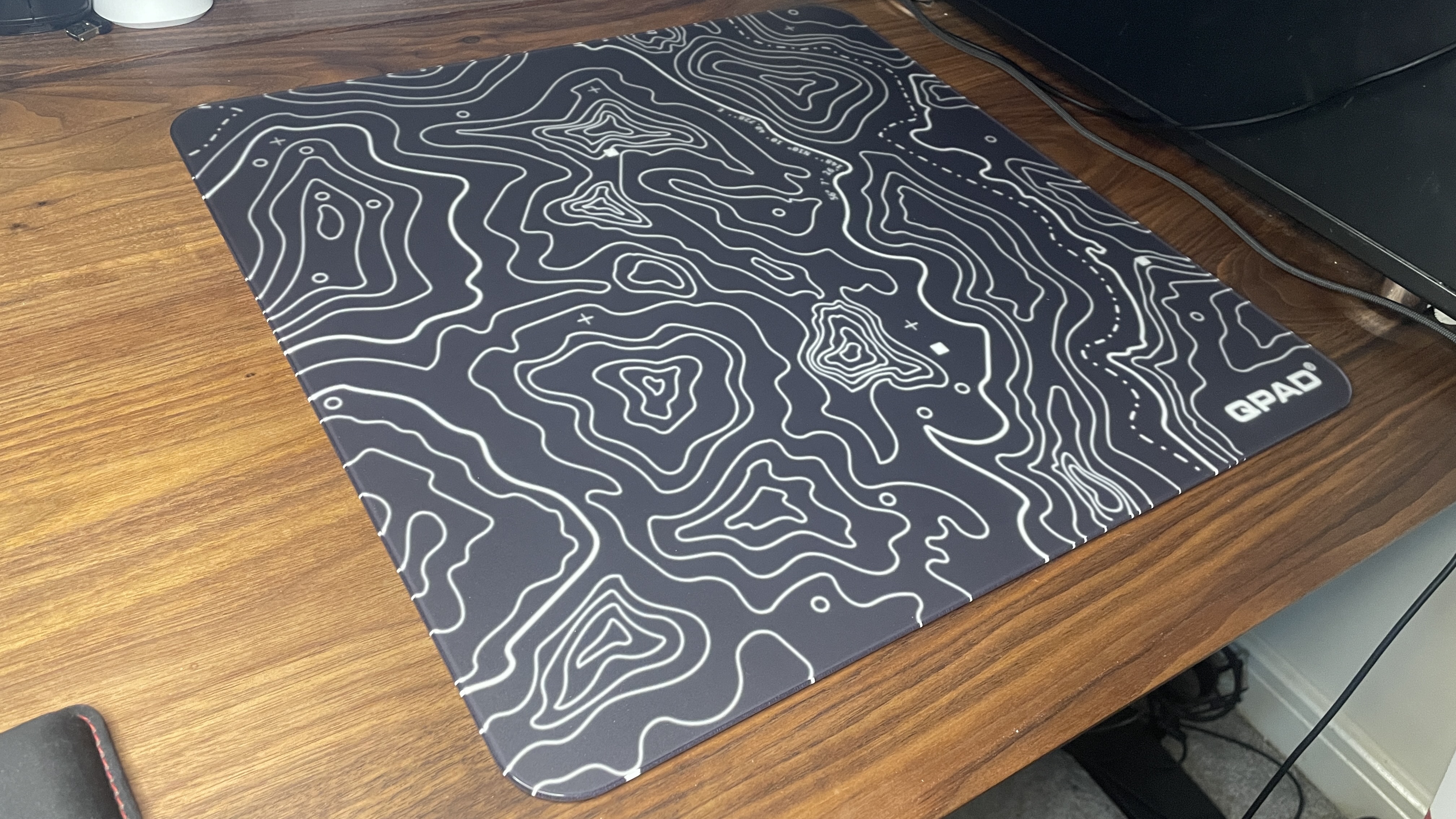 A QPAD Obsidian Glass mouse pad.