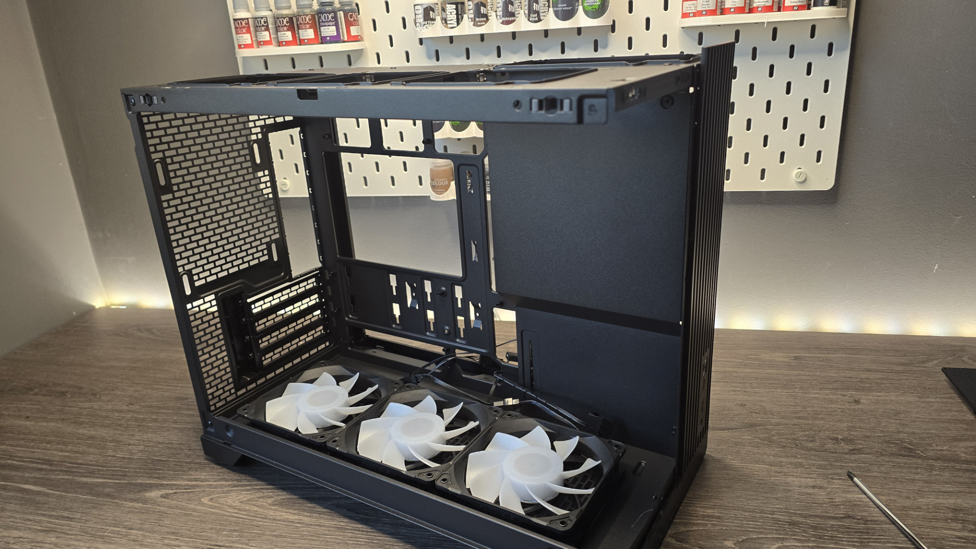 A Phanteks XT V3 PC case on a desk with various PC parts.