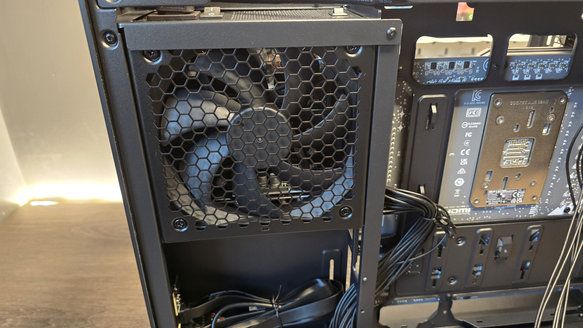 A Phanteks XT V3 PC case on a desk with various PC parts.