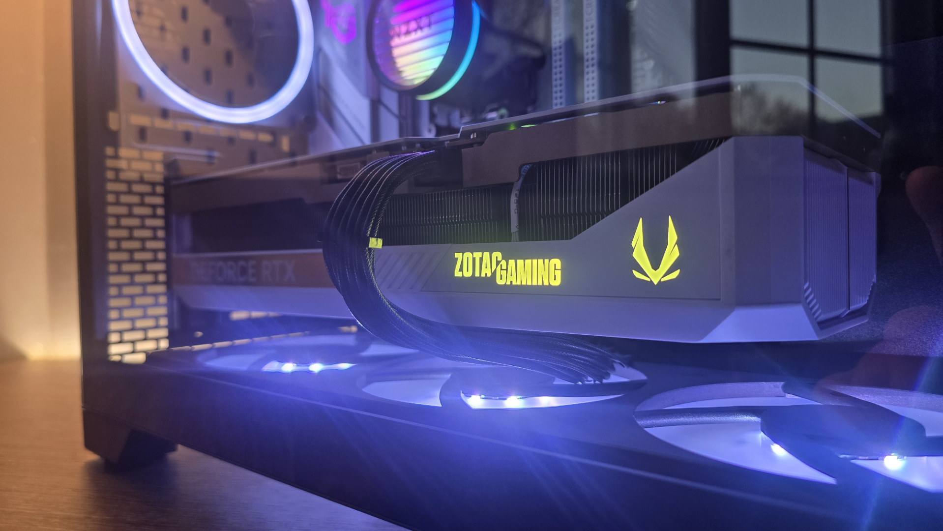 A Phanteks XT V3 PC case on a desk with various PC parts.