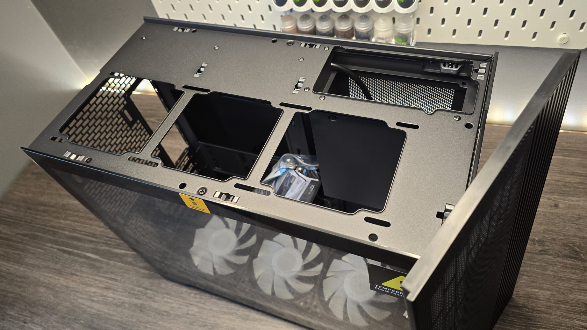 A Phanteks XT V3 PC case on a desk with various PC parts.