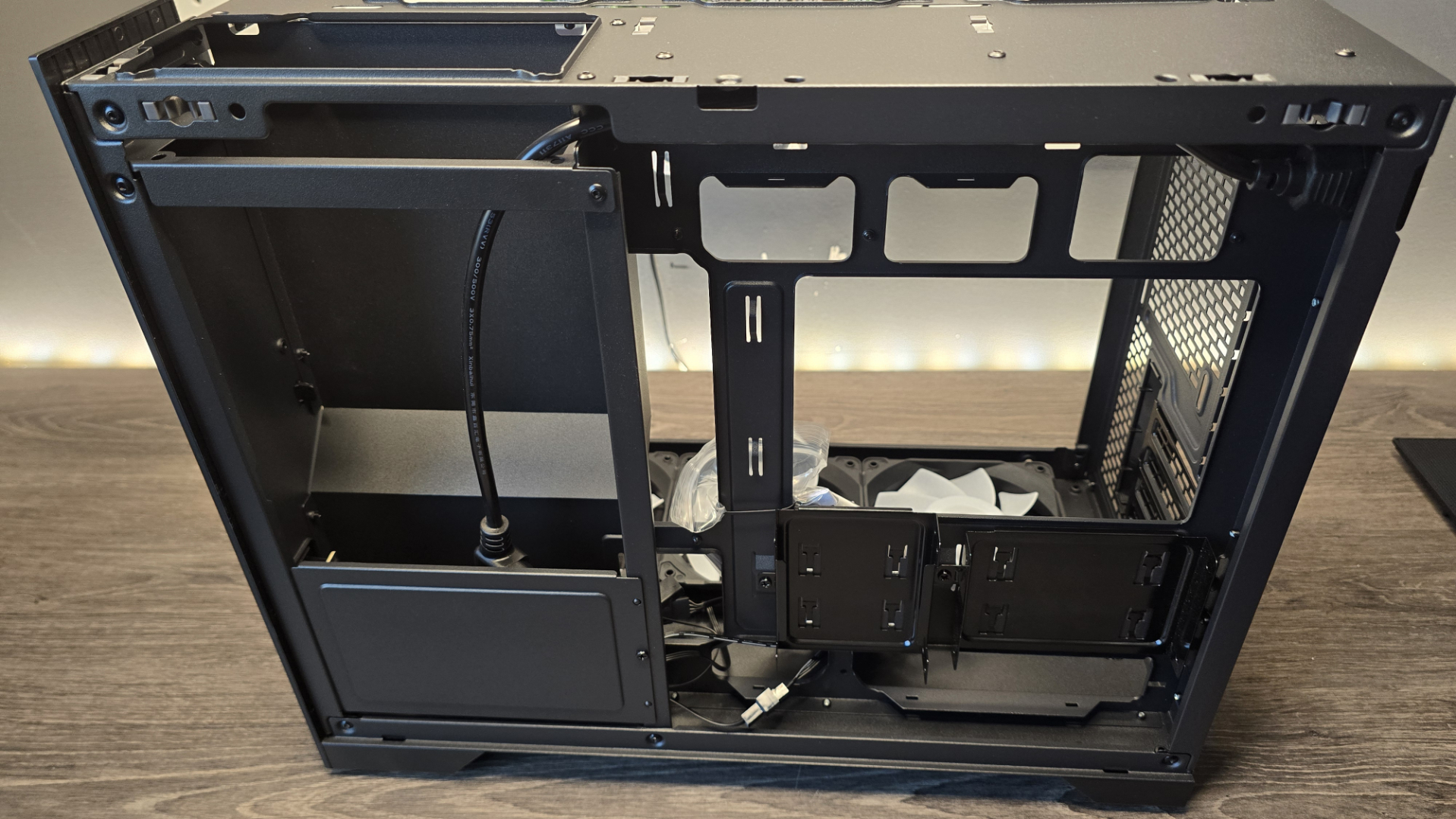 A Phanteks XT V3 PC case on a desk with various PC parts.